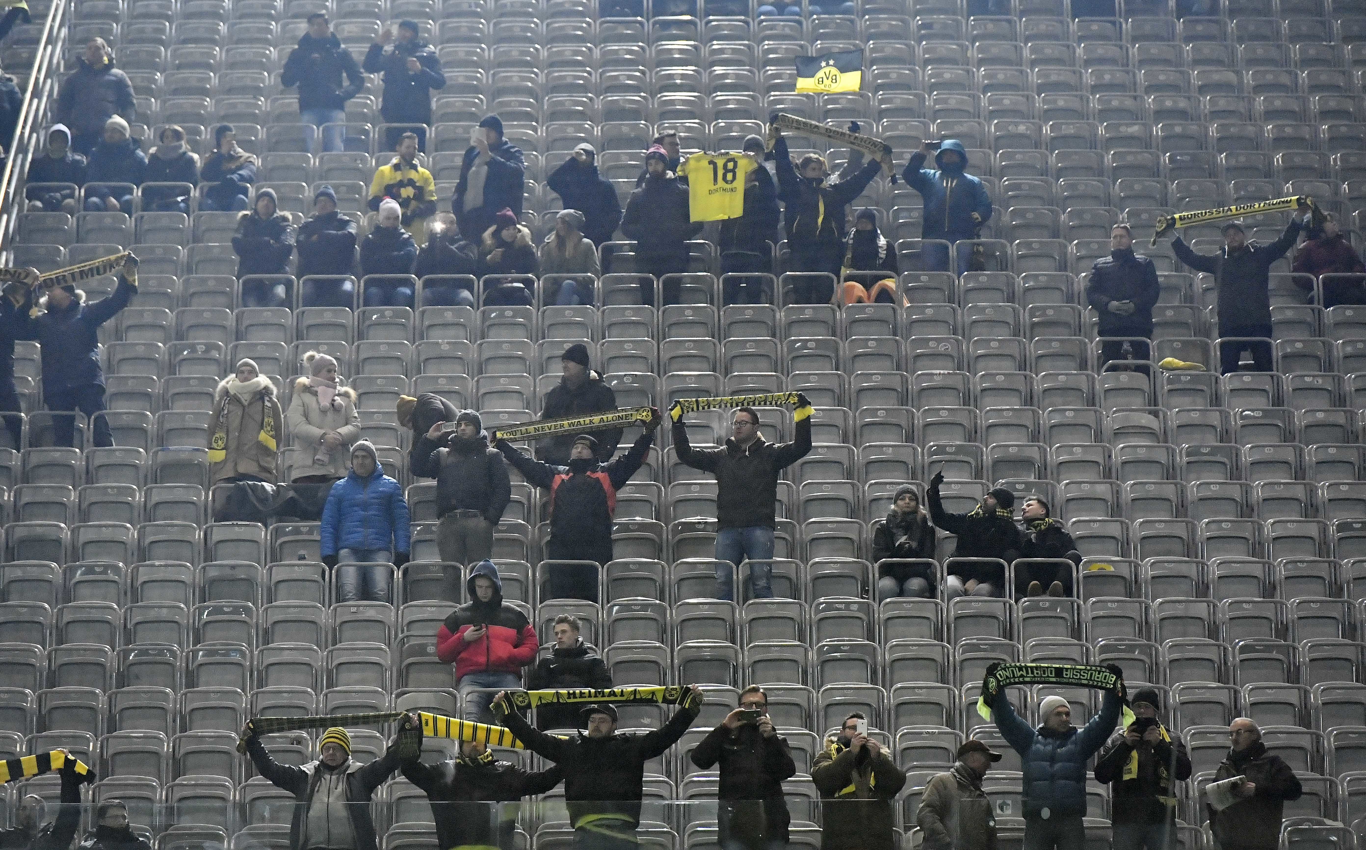 Fans stay away in protest as Augsburg holds Dortmund 1-1