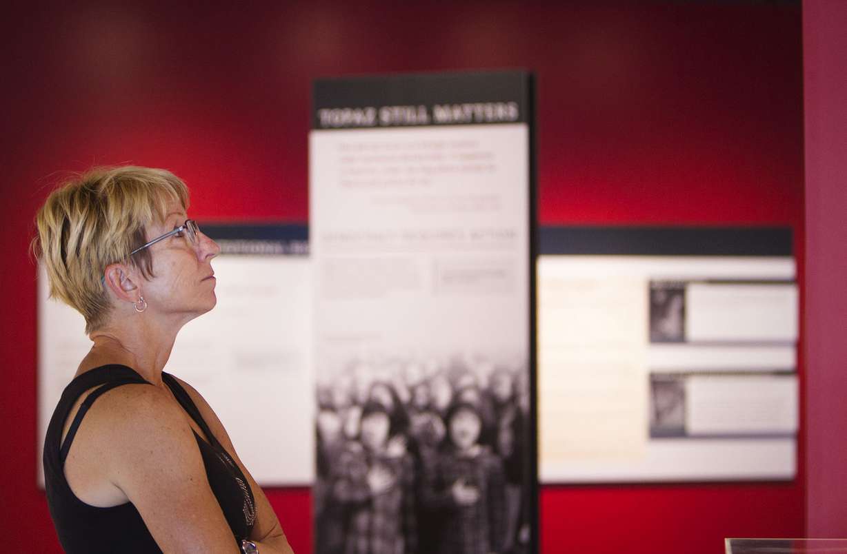 Kim Spragg reads displayed information during the opening weekend of the new Topaz Museum in Delta on Friday, July 7, 2017. Spragg and her husband, Mark, were driving through Delta and stopped to look at the museum. The couple live in Florida. (Photo: Kelsey Brunner, KSL)
