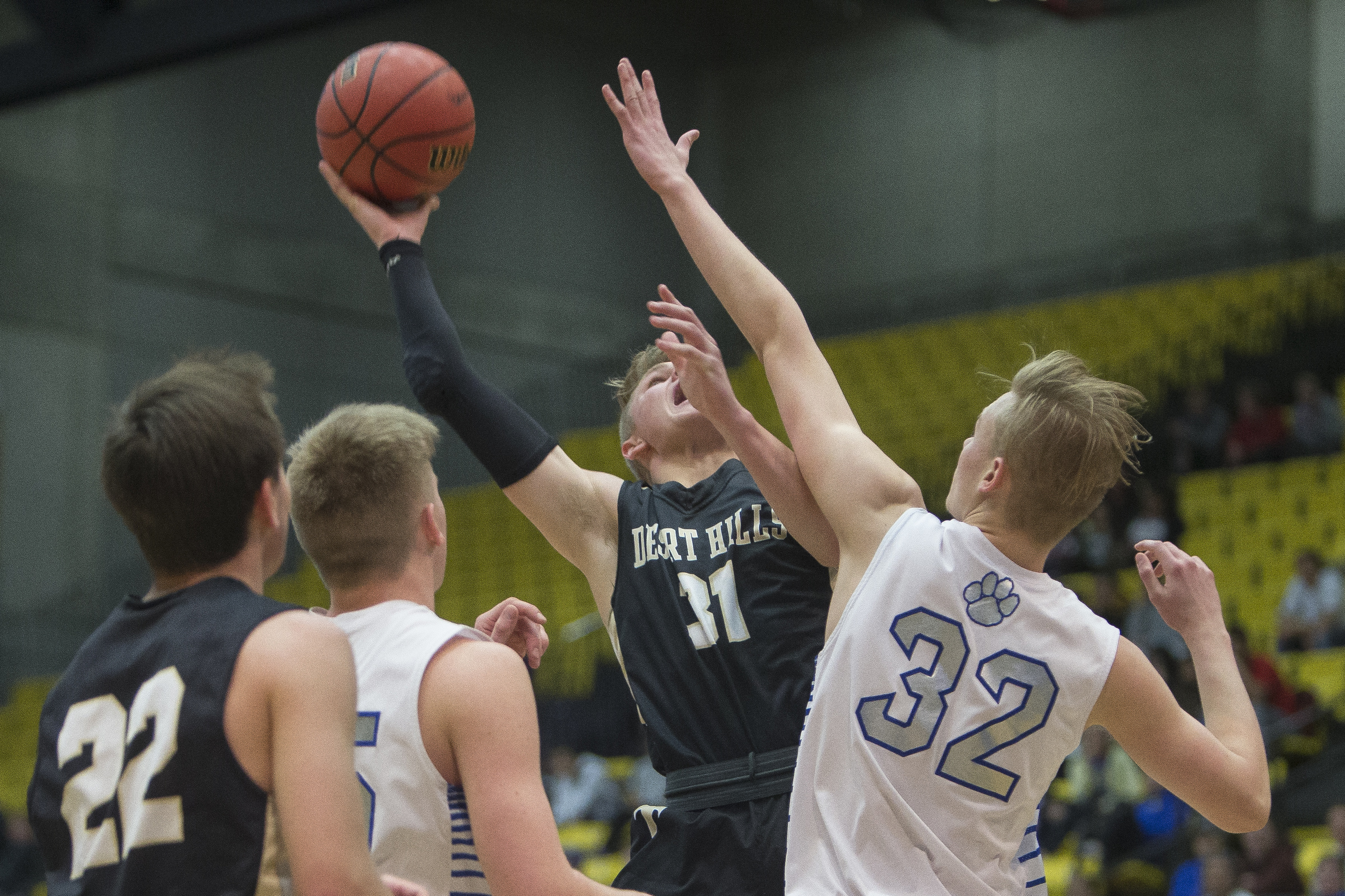 Desert Hills' Tucker Peterson puts up a shot while guarded by Orem's Isaac Richards (25) and Taylor Hockersmith (32) during Orem's 71-56 victory against Desert Hills in the Class 4A state quarterfinals at the Utah Valley University in Orem on Thursday, March 1, 2018.
(Photo: Jacob Wiegand, Deseret News)