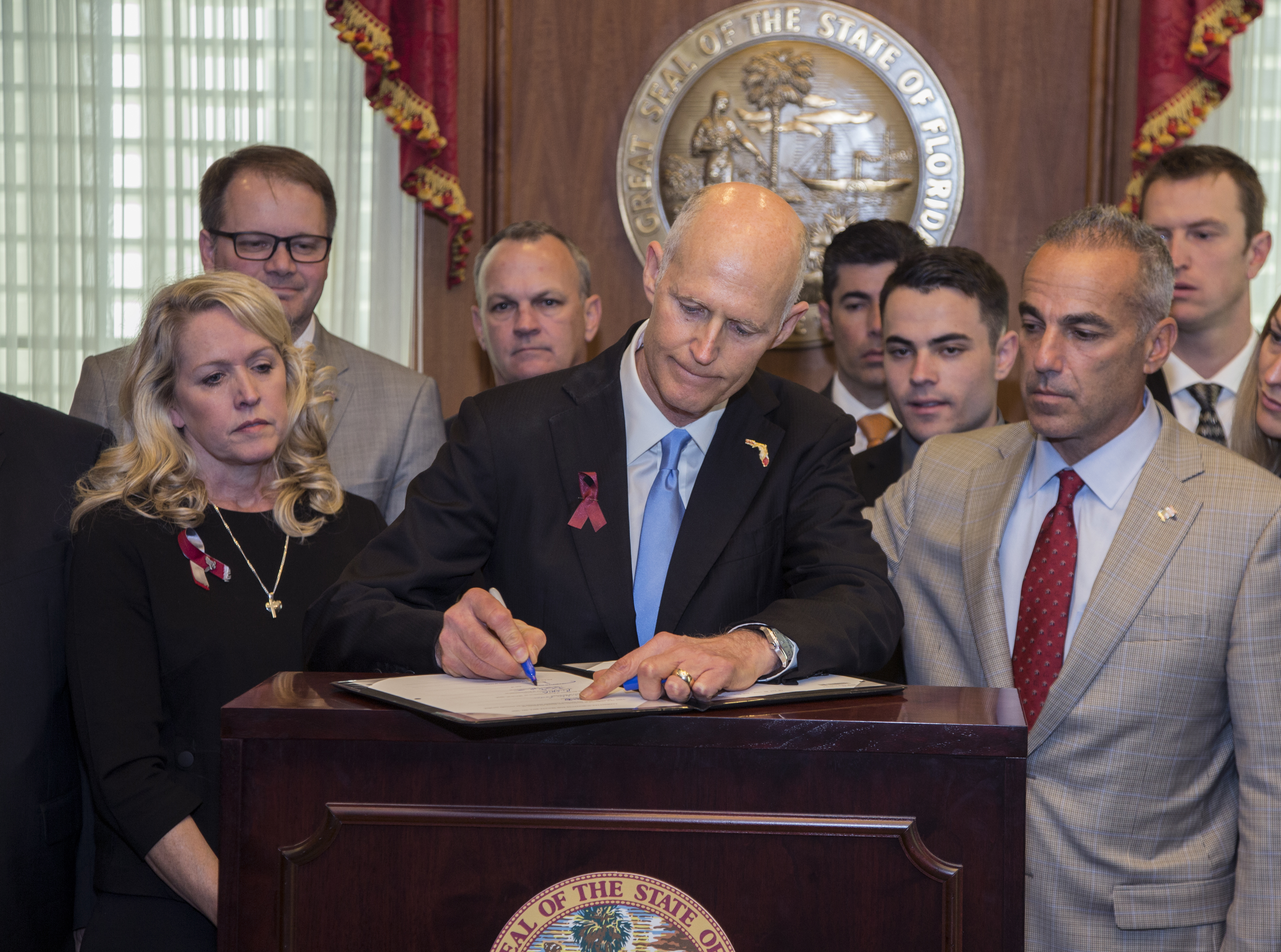 Florida governor signs gun restrictions 3 weeks after attack