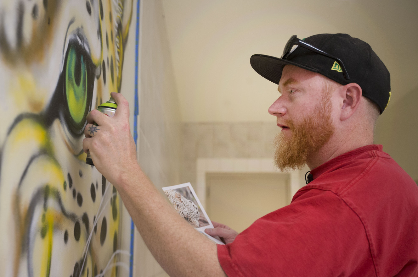 Graffiti artist Matt Chew spray-paints murals in the hallway of the East High School washrooms for homeless students in Salt Lake City on Thursday, March 8, 2018. (Photo: Laura Seitz, KSL)