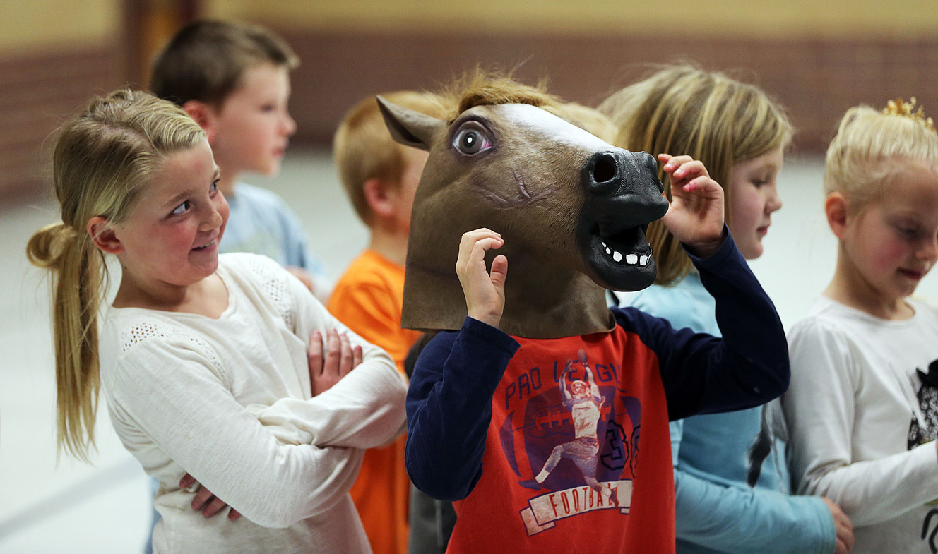 Second-grader Chezni Nelson takes a long look at classmate AJ Hult as he tries on a horse head mask during the Champion Challenge Rodeo Assembly at Brockbank Elementary School in Spanish Fork on Monday, Feb. 27, 2017. The challenge encourages students to read. (Photo: Ravell Call, KSL)