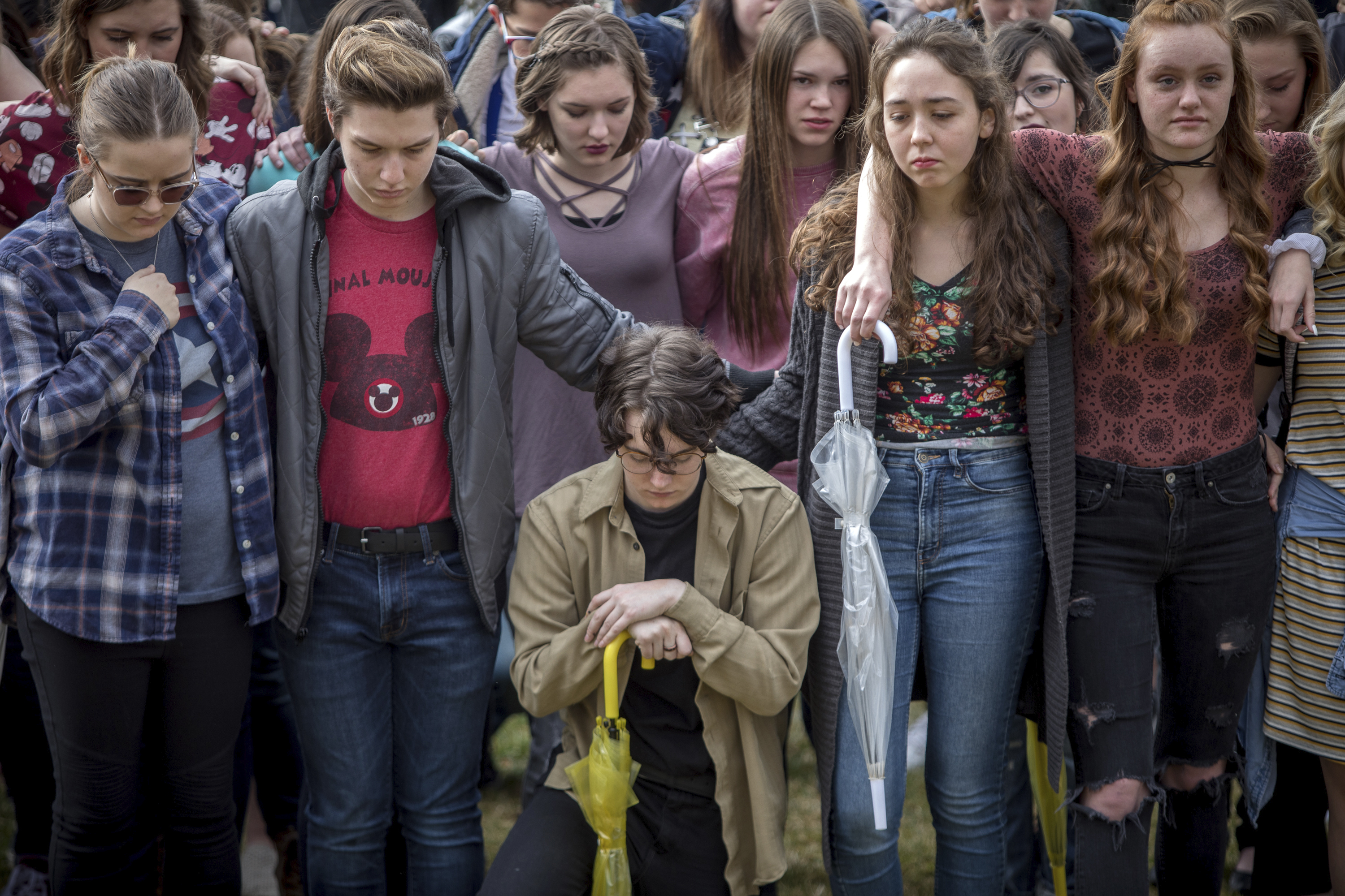 Students at Weber High School observe a moment of silence as the names of the victims from the Marjory Stoneman Douglas High School shooting are read aloud during a school walkout in Pleasant View, Utah on Wednesday, March 14, 2018. Students across the country planned to participate in walkouts Wednesday to protest gun violence. (Benjamin Zack, Standard-Examiner via AP)