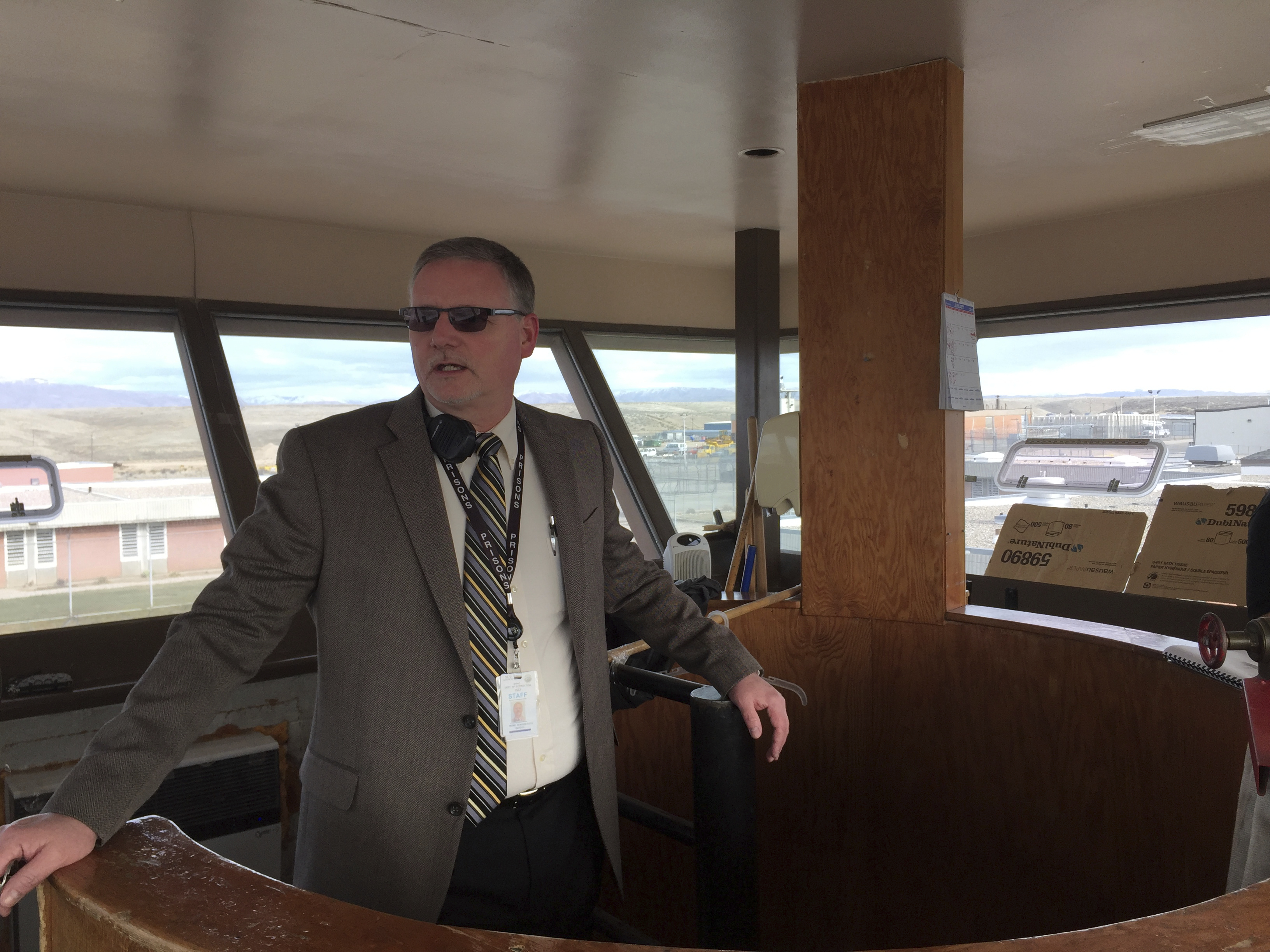 In this Jan. 30, 2018 photo Idaho State Correctional Institution Warden Keith Yordy looks out at the prison yard from inside a watch tower in the center of the prison grounds in Kuna, Idaho. The medium-security prison south of Boise was where Glenn Cox, serving time on a drunken driving charge, was assaulted and killed in his cell last fall. (AP Photo/Rebecca Boone)