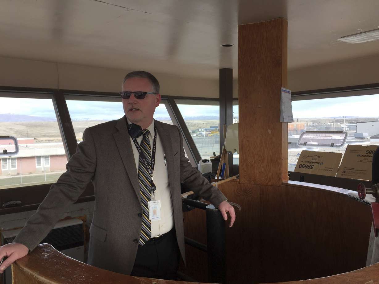 In this Jan. 30, 2018 photo Idaho State Correctional Institution Warden Keith Yordy looks out at the prison yard from inside a watch tower in the center of the prison grounds in Kuna, Idaho. The medium-security prison south of Boise was where Glenn Cox, serving time on a drunken driving charge, was assaulted and killed in his cell last fall. (AP Photo/Rebecca Boone)