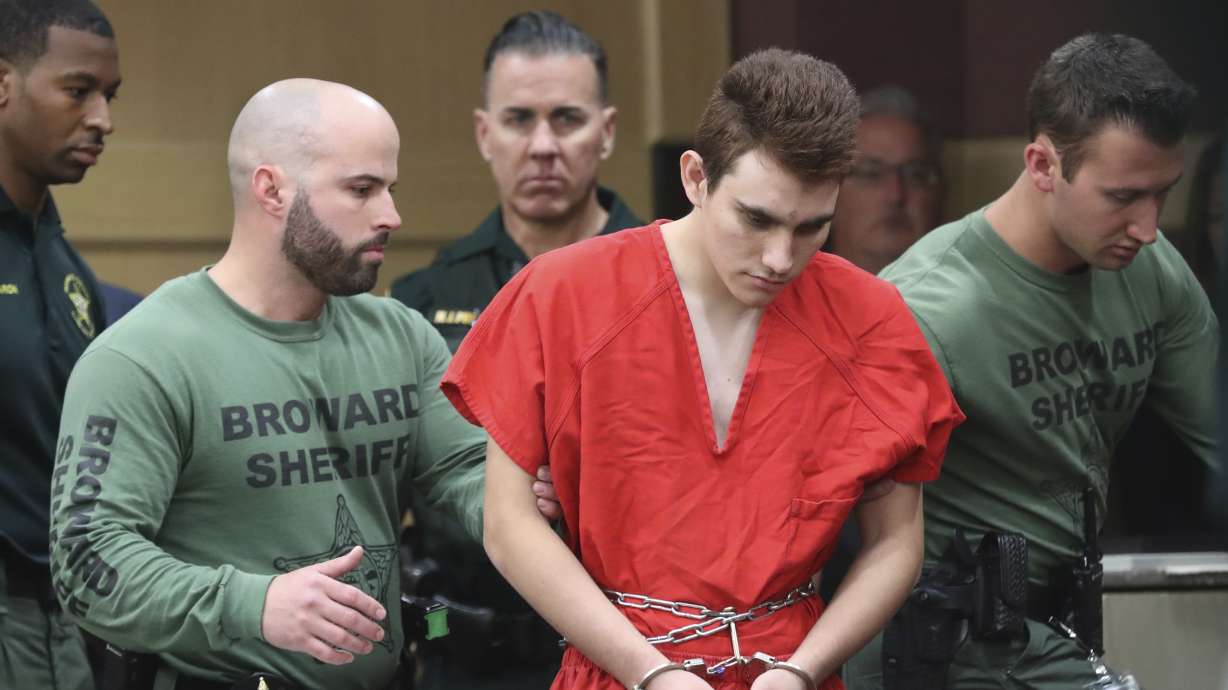 The Latest: Video shows officer outside during massacre