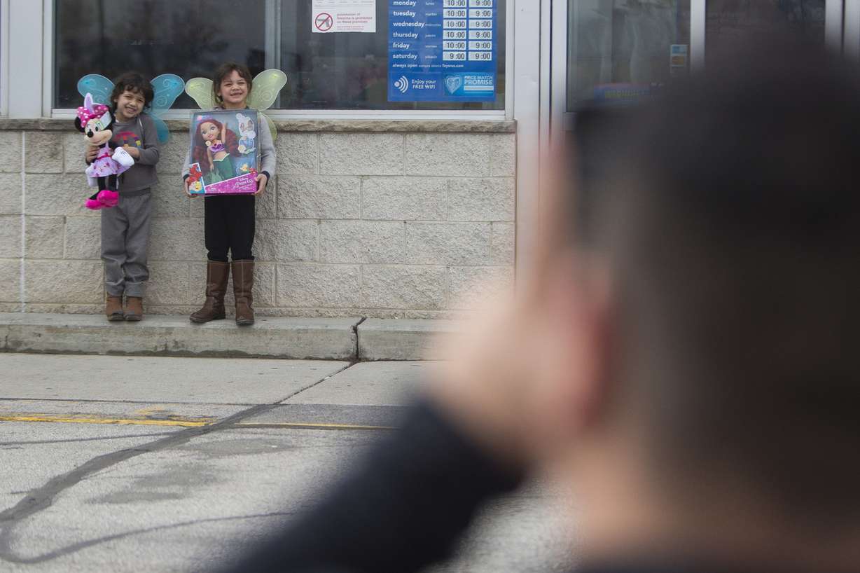 Gabriel Harrison-Benevides of Afton, Wyoming, takes a picture after shopping with his nieces Rubie Benevides, 5, and her sister, Diamond Benevides, who will turn 6 on Saturday, both also of Afton, outside the Toys 'R' Us in Murray on Thursday, March 15, 2018. The toy retailer plans to close or sell more than 700 stores across the country. (Photo: Jacob Wiegand, KSL)