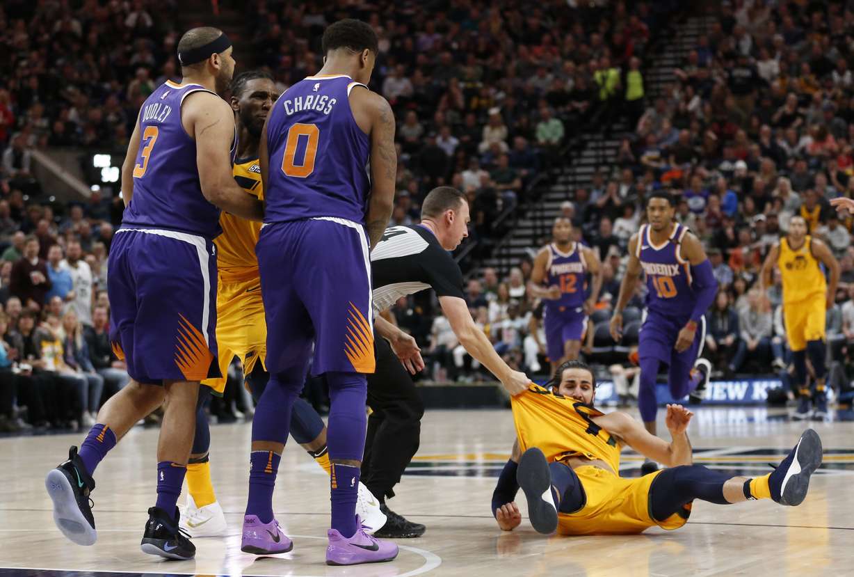 Phoenix Suns' Jared Dudley (3) and Marquese Chriss (0) stand nearby after shoving Utah Jazz's Ricky Rubio, right, to the court during the second of an NBA basketball game Thursday, March 15, 2018, in Salt Lake City. (AP Photo, Rick Bowmer)