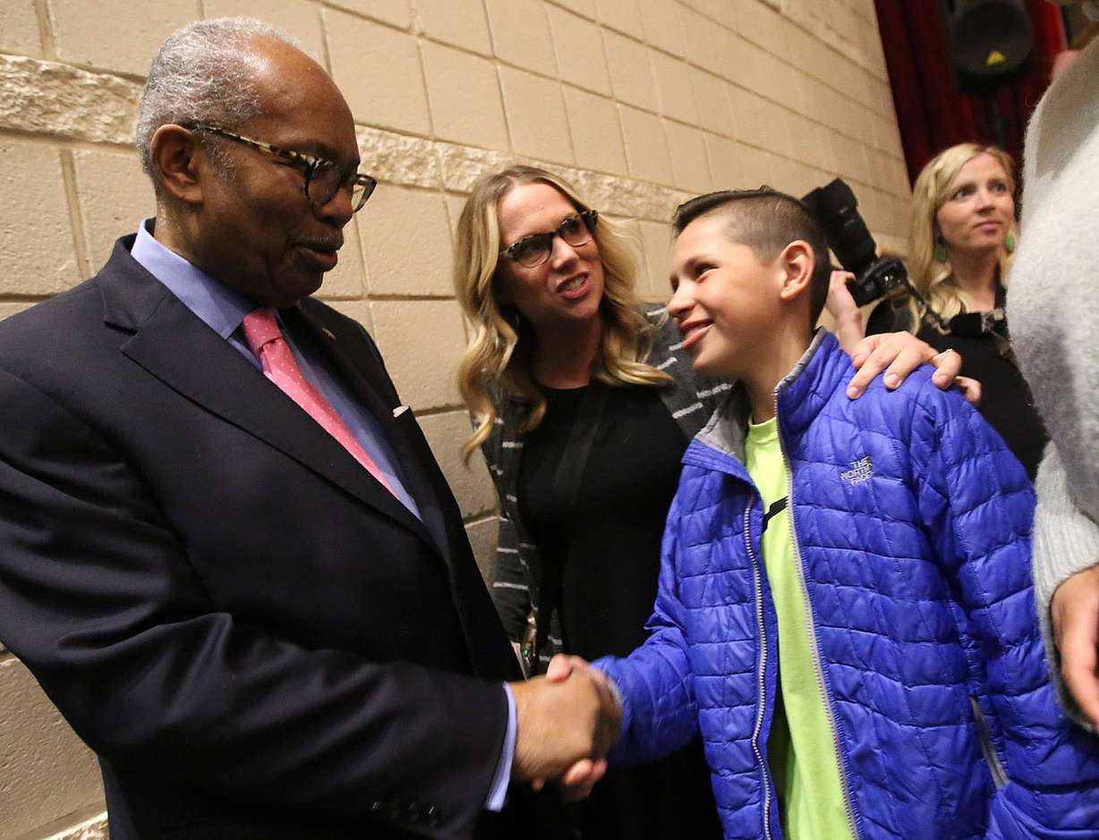 Ernest Green, the oldest member of the Little Rock Nine and the first African-American to graduate from Central High School in 1958 in Little Rock, Arkansas, shakes hands with seventh-grader Gauge Vause at Davis High School in Kaysville on Thursday, March 22, 2018. (Photo: Kristin Murphy, KSL)