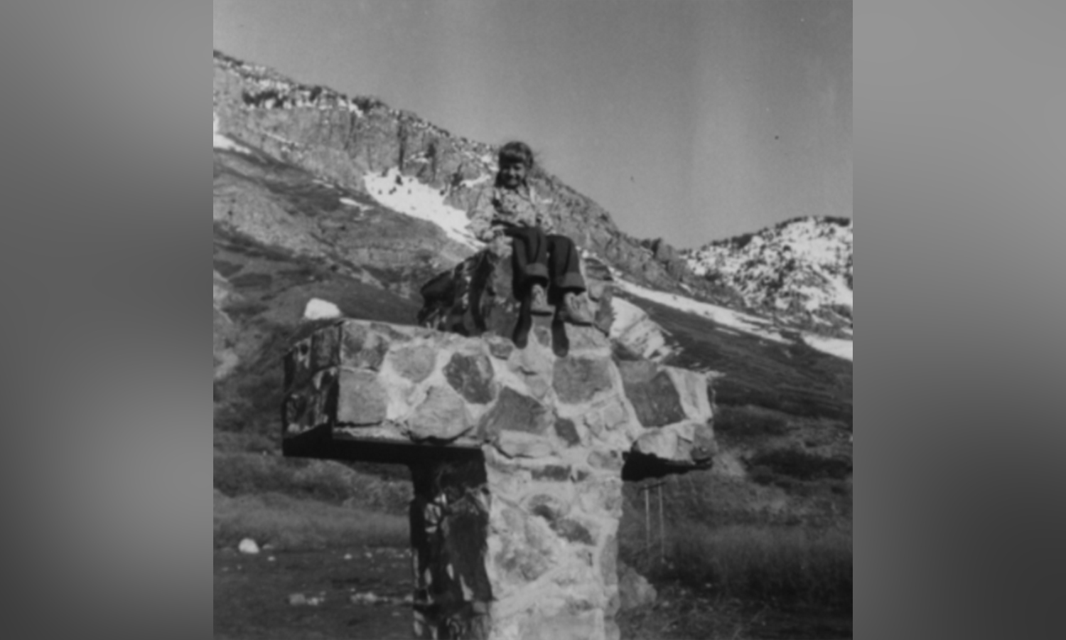 A photo of a girl sitting on the Provo Easter cross. The cross, built in 1939, was bulldozed in the 1970s. (Photo Courtesy Niki Thornock)