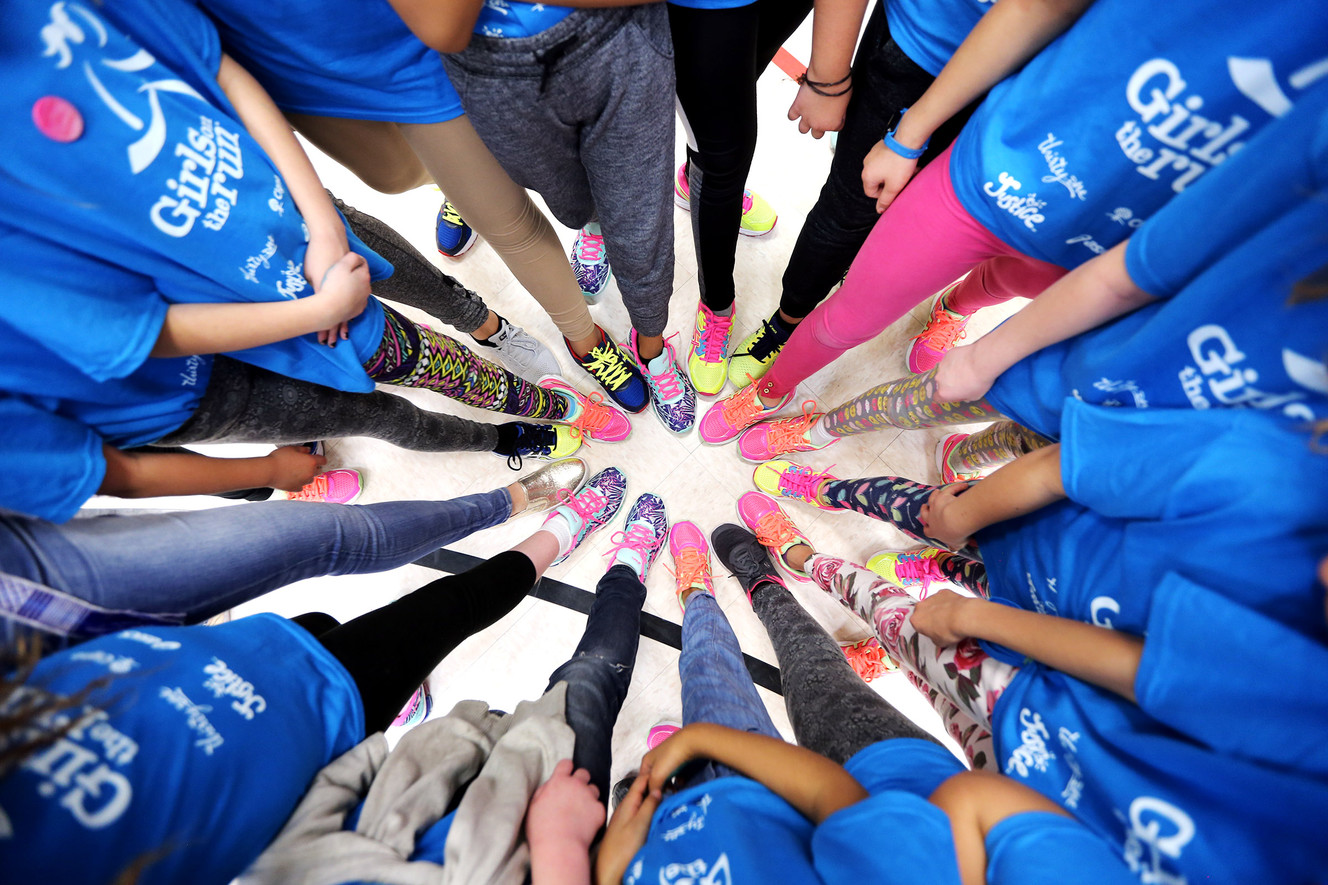 A group of students at Escalante Elementary School in North Salt Lake show off their new running shoes on Friday, March 23, 2018. The shoes were donated to the students by Girls on the Run, a nonprofit after-school character development program, and ASICS, a sports equipment company. More than 700 free pairs of running shoes will be given to local girls. (Photo: Scott G Winterton, KSL)