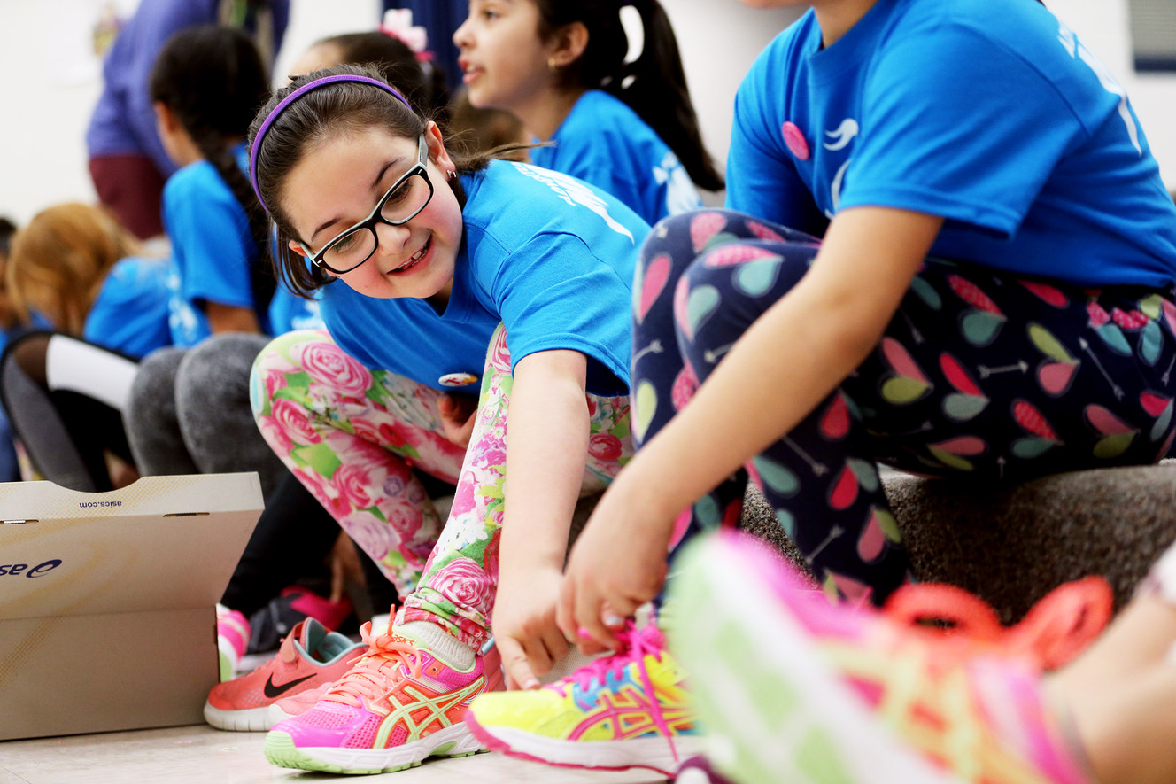 Ava Segura, a student at Escalante Elementary School in North Salt Lake, points to details on a new pair of running shoes on Friday, March 23, 2018. The shoes were donated to the students by Girls on the Run, a nonprofit after-school character development program, and ASICS, a sports equipment company. More than 700 free pairs of running shoes will be given to local girls. (Photo: Scott G Winterton, KSL)