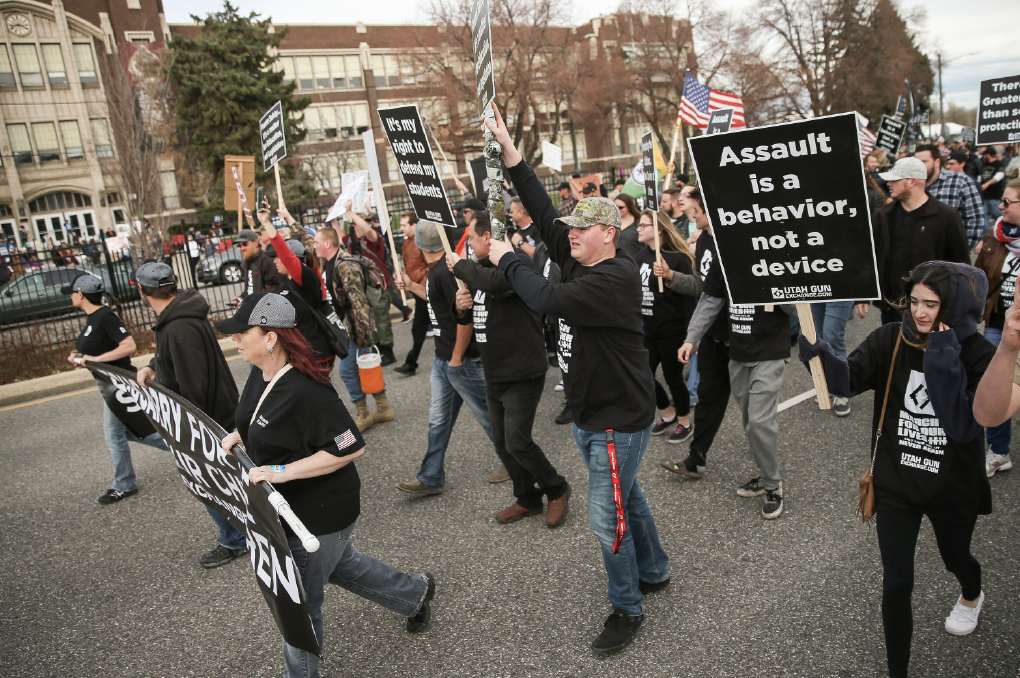 The pro-gun "March Before Our Lives" participants walk past West High School in Salt Lake City on Saturday, March 24, 2018. The pro-gun march immediately preceded the "March for Our Lives" rally, which called for stricter gun control. (Spenser Heaps, KSL)