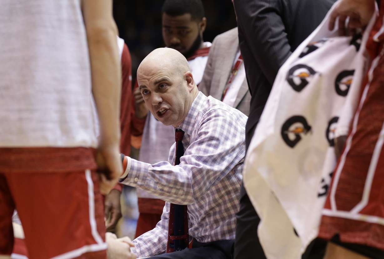 South Dakota head coach Craig Smith speaks with players during a timeout against Duke during the first half of an NCAA college basketball game in Durham, N.C., Saturday, Dec. 2, 2017. (AP Photo, Gerry Broome)