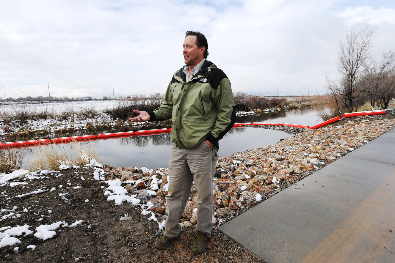 Chris Brown, manager of the Great Salt Lake Shorelands Preserve, talks about the trash being collected by a new floating boom on the Jordan River in North Salt Lake on Monday, March 26, 2018. (Photo: Scott G Winterton, KSL)