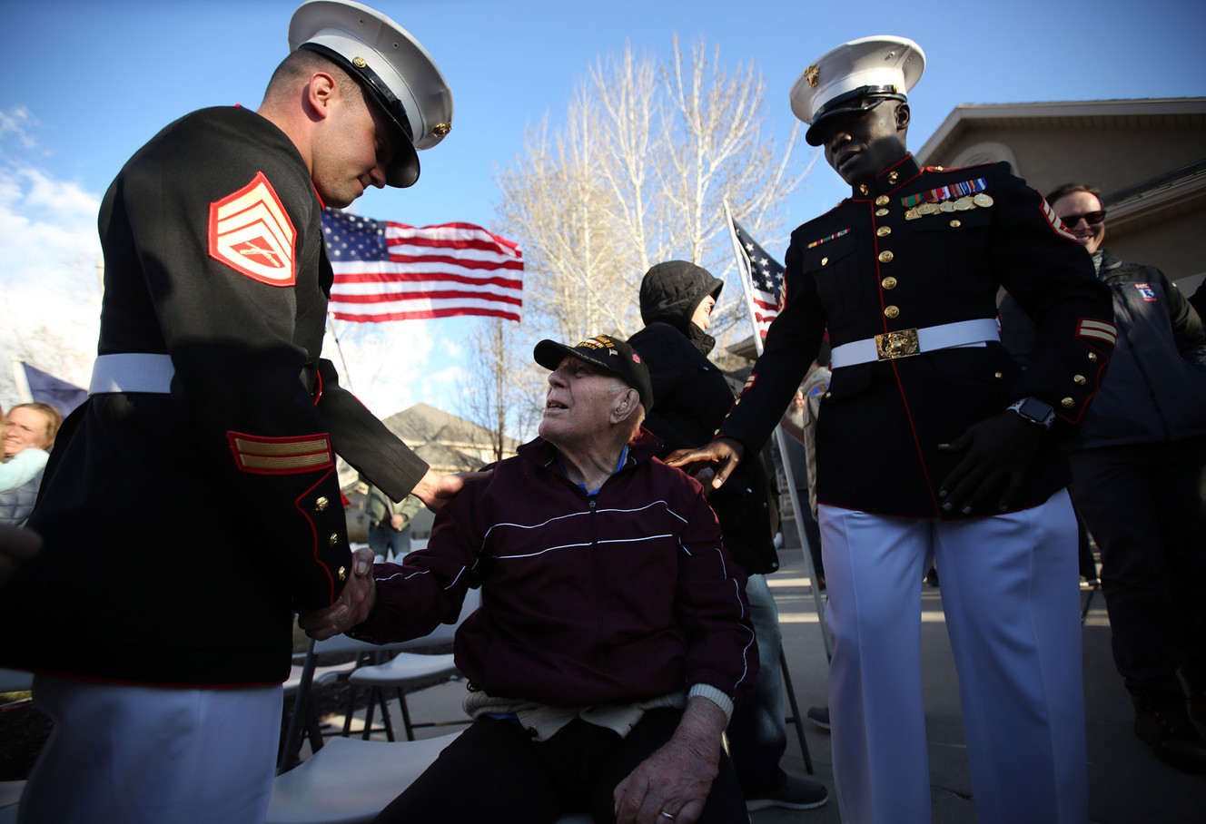 Staff Sgt. Daniel Cloyd, left, shakes hands with World War II Master Gunnery Sgt. Keith Renstrom at a celebration honoring Renstrom's service and his 97th birthday in Pleasant Grove on Monday, March 26, 2018. Staff Sgt. Okuni Mawa is on the right. (Photo: Kristin Murphy, Deseret News)