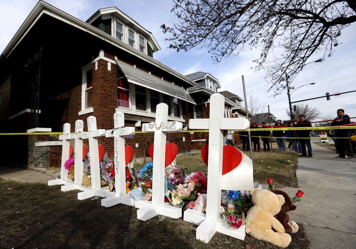 Mourners pay their respect outside a home in Chicago where six family members were found dead in on Feb. 4, 2016. Arrests were later made in the homicide case. (Nam Y. Huh, AP Photo, File)