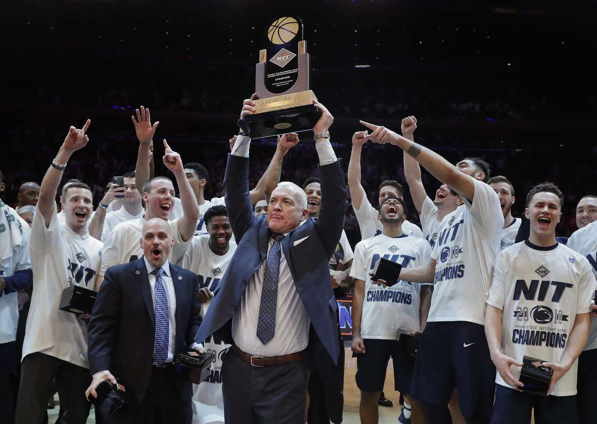 Penn State coach Pat Chambers holds up the NIT championship trophy after Penn State defeated Utah 82-66 in an NCAA college basketball game Thursday, March 29, 2018, in New York. (Julie Jacobson, AP Photo)