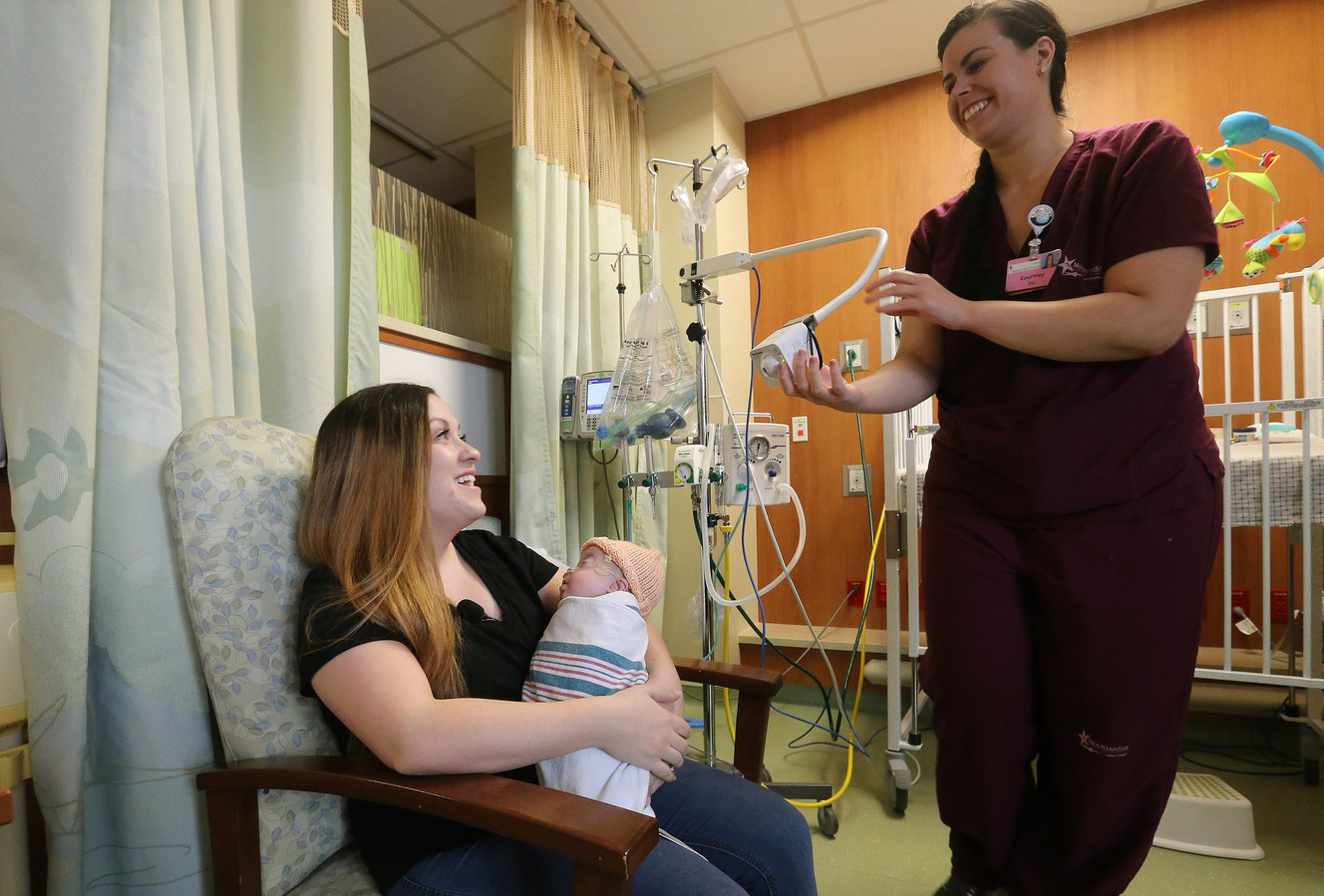 Courtney Tipton, a registered nurse in the neonatal intensive care unit at Timpanogos Regional Hospital in Orem, aims a webcam at newborn John Carter Girtman and his mother, Mary Girtman, on Friday, March 23, 2018. John is recovering from pneumonia and new webcam technology allows his deployed father to see live video of him. (Photo: Jeffrey D. Allred, KSL)