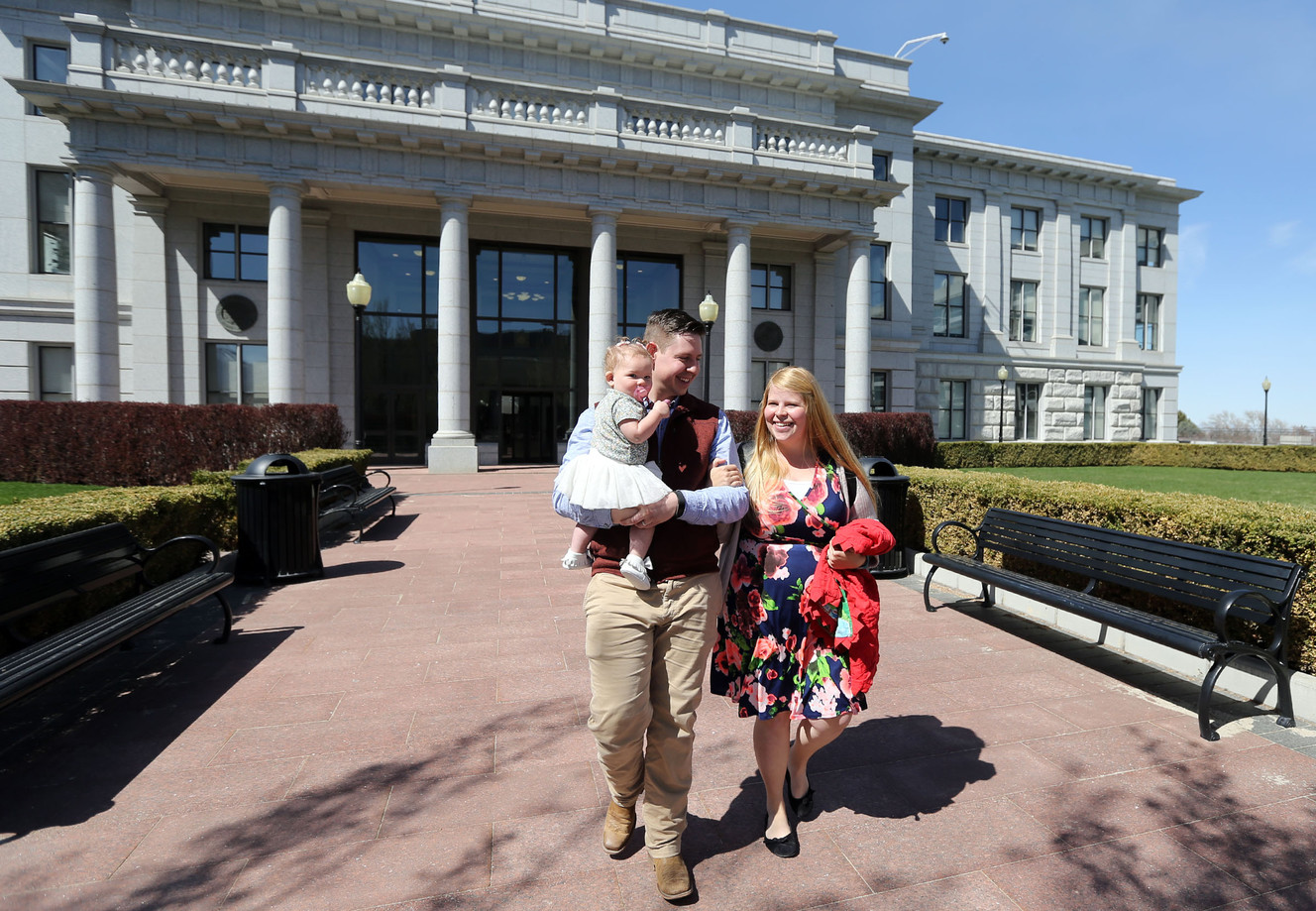 Josh Bird, holding Lydia Jane Bird, and Amber Bird leave a Women in the Economy Commission meeting on Utah’s Capitol Hill in Salt Lake City on Tuesday, April 3, 2018. The Birds are expecting their second child, and Amber will pursue a master's in English this year. (Photo: Kristin Murphy, KSL)