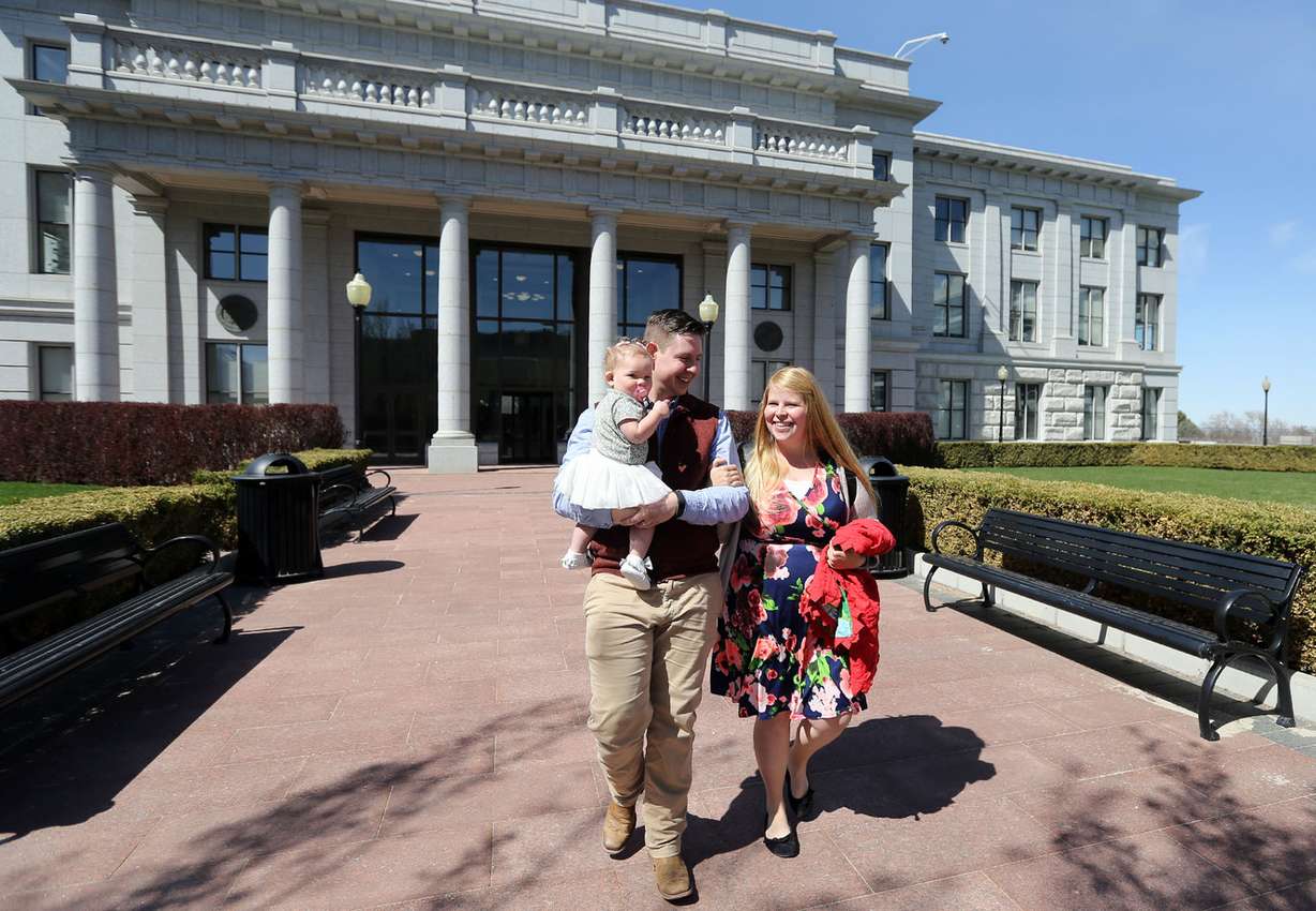 Josh Bird, holding Lydia Jane Bird, and Amber Bird leave a Women in the Economy Commission meeting on Utah’s Capitol Hill in Salt Lake City on Tuesday, April 3, 2018. The Birds are expecting their second child, and Amber will pursue a master's in English this year. (Photo: Kristin Murphy, KSL)