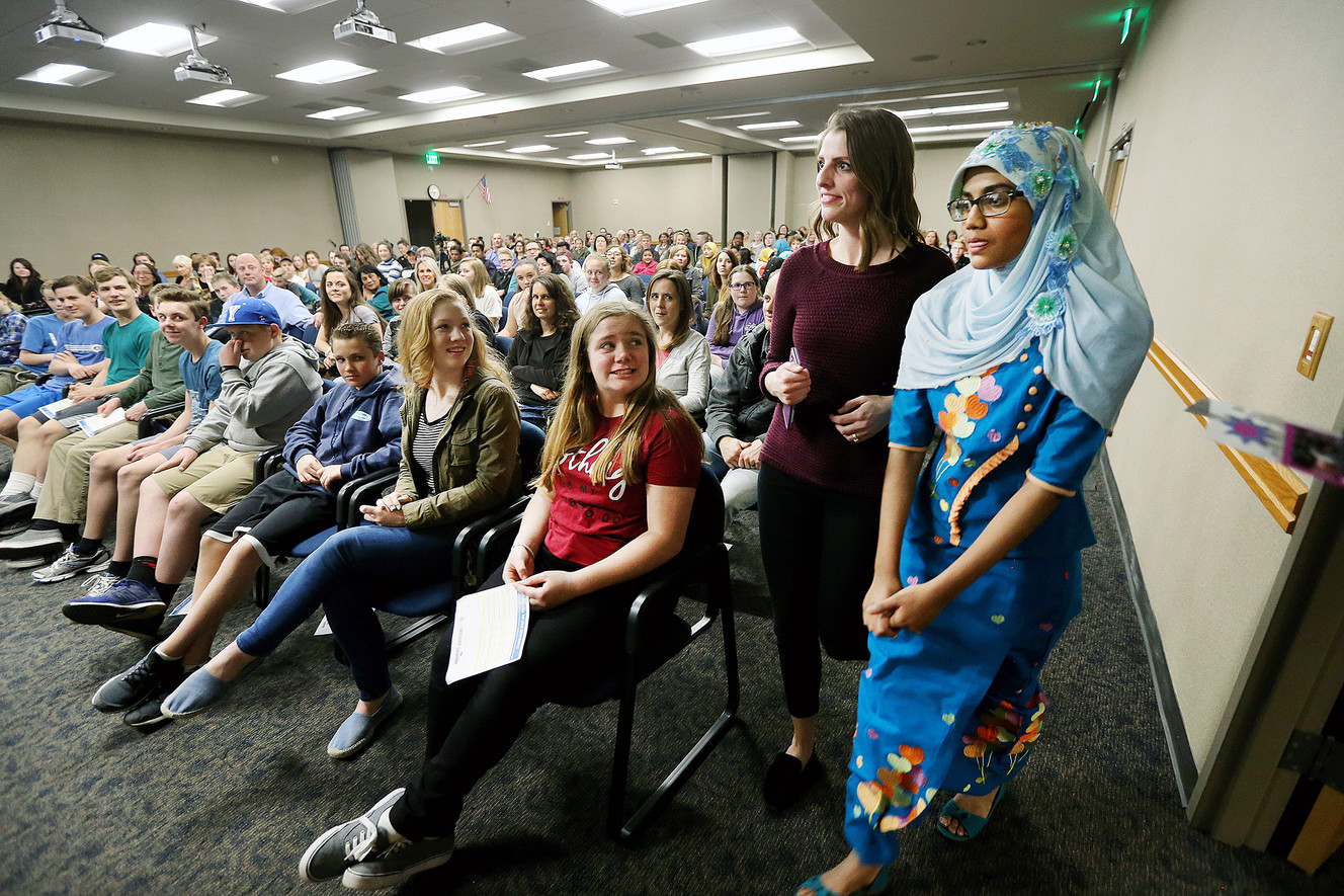 Madeleine Clark-Aud, with Granite School District, walks to the podium with Rashidah Munir during the Rohingya Cultural Night in Salt Lake City on Wednesday, April 4, 2018. (Photo: Scott G Winterton, KSL)