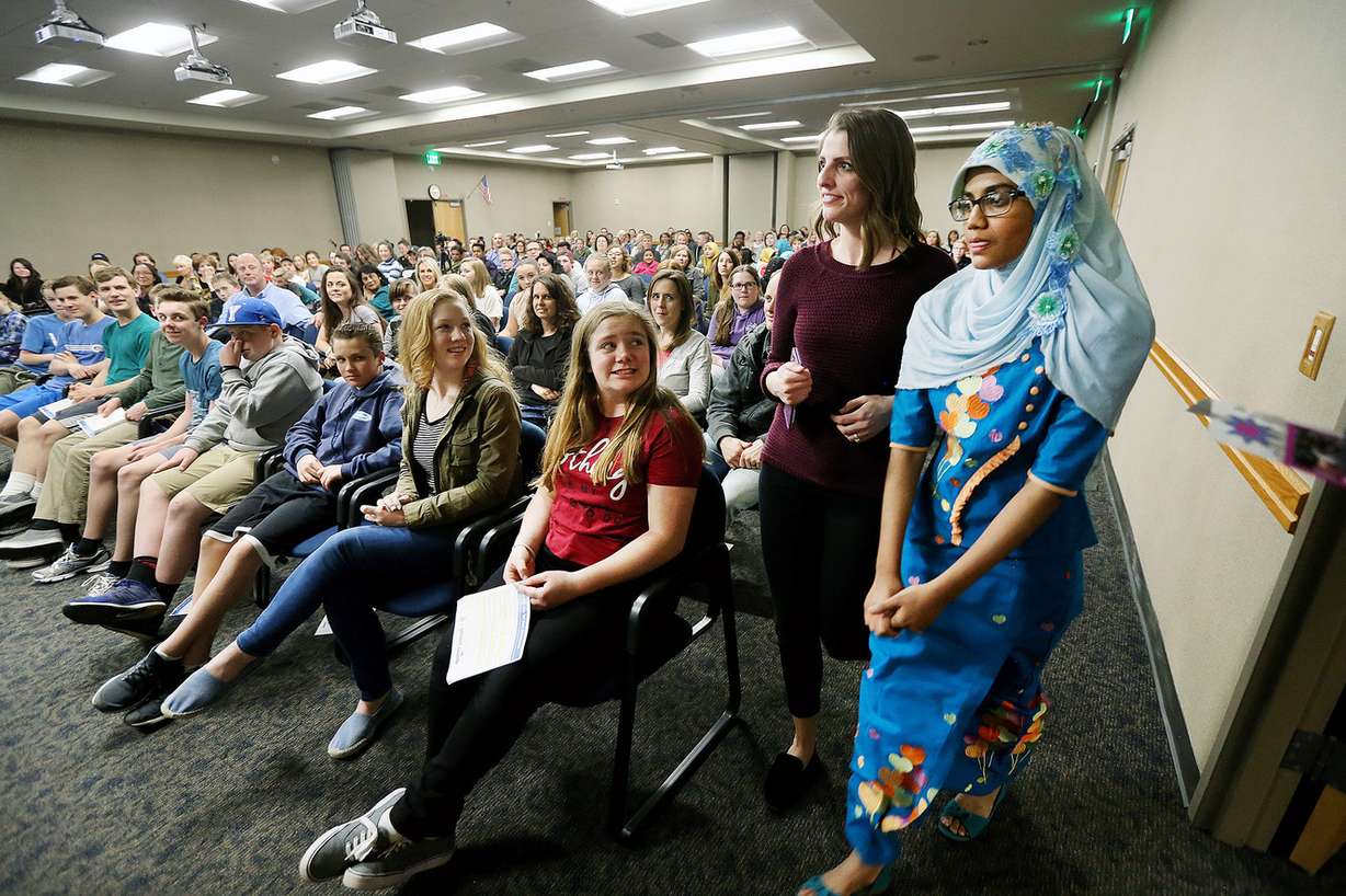 Madeleine Clark-Aud, with Granite School District, walks to the podium with Rashidah Munir during the Rohingya Cultural Night in Salt Lake City on Wednesday, April 4, 2018. (Photo: Scott G Winterton, KSL)