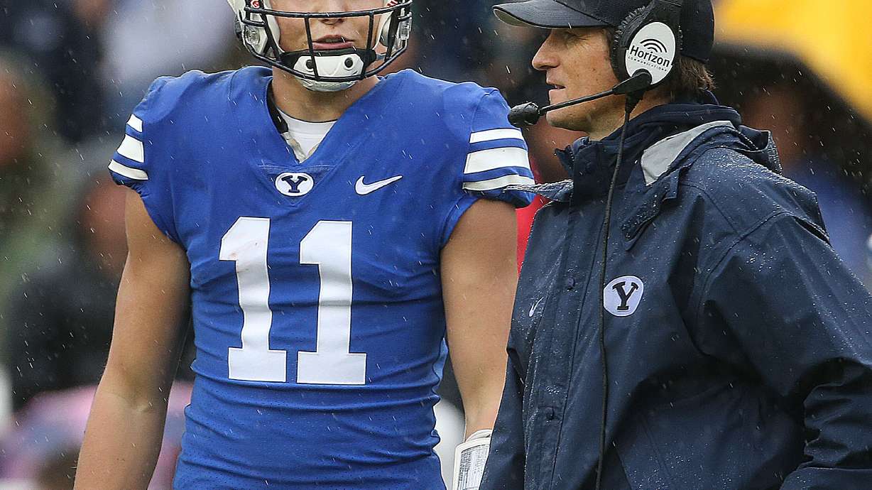 BYU's QB Zach Wilson and QB coach Aaron Roderick confer during the Blue-White game at LaVell Edwards Stadium in Provo on Saturday, April 7, 2018.