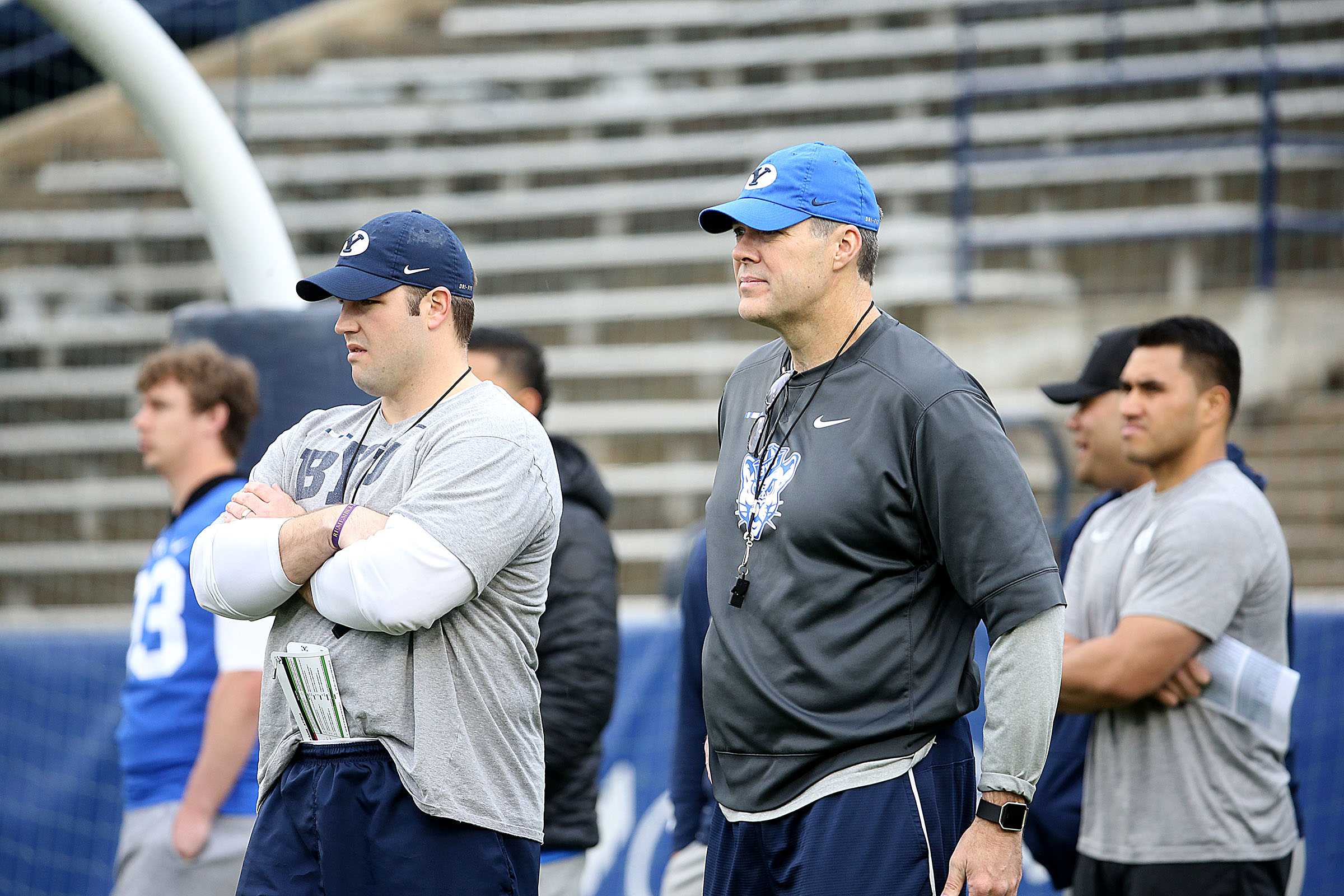 Offensive coordinator Jeff Grimes, right, and offensive line coach Ryan Pugh watch the players warm up before the Blue-White game at LaVell Edwards Stadium in Provo on Saturday, April 7, 2018. (Photo: Laura Seitz, KSL)