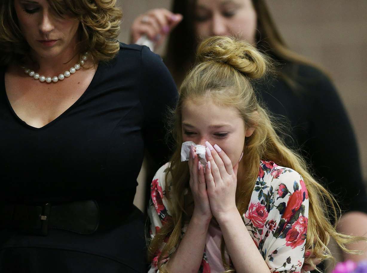 Madison Otteson, sister of Brelynne “Breezy” Otteson, and her aunt, Amanda Hunt, cry during a memorial service for her and Riley Powell in Eureka on Saturday, April 7, 2018. (Photo: Jeffrey D. Allred, KSL)