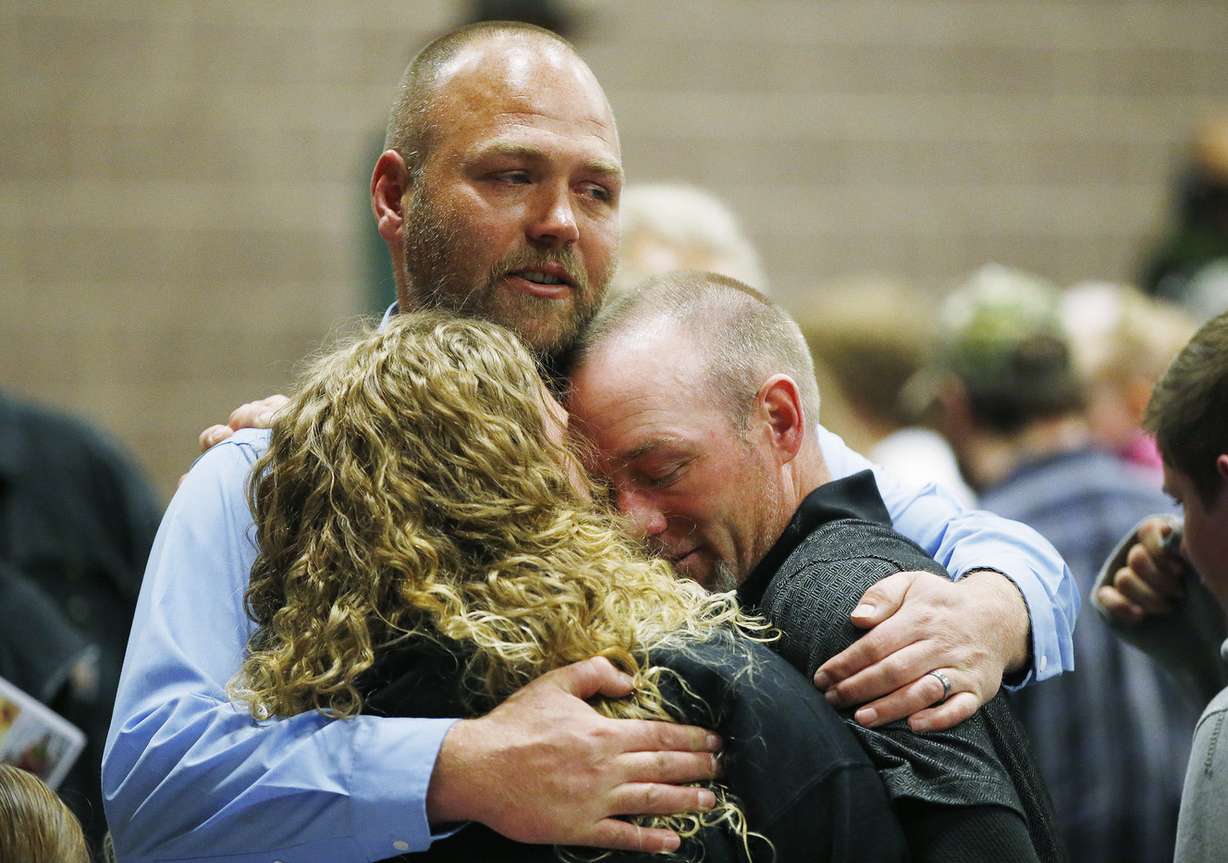 Kenny and Emalee Otteson, parents of Brelynne “Breezy” Otteson, are hugged by James Newton, an uncle of Breezy, during a memorial service in Eureka on Saturday, April 7, 2018. (Photo: Jeffrey D. Allred, KSL)
