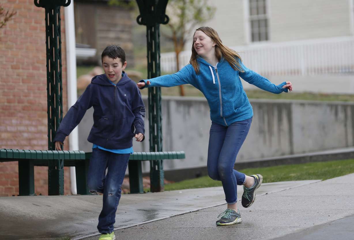 In this April 6, 2018, photo, Caleb Coulter, 10, left, and his sister Kendra, 12, play tag during a visit to the Place Heritage Park in Salt Lake City. Photo: Rick Bowmer, AP Photo