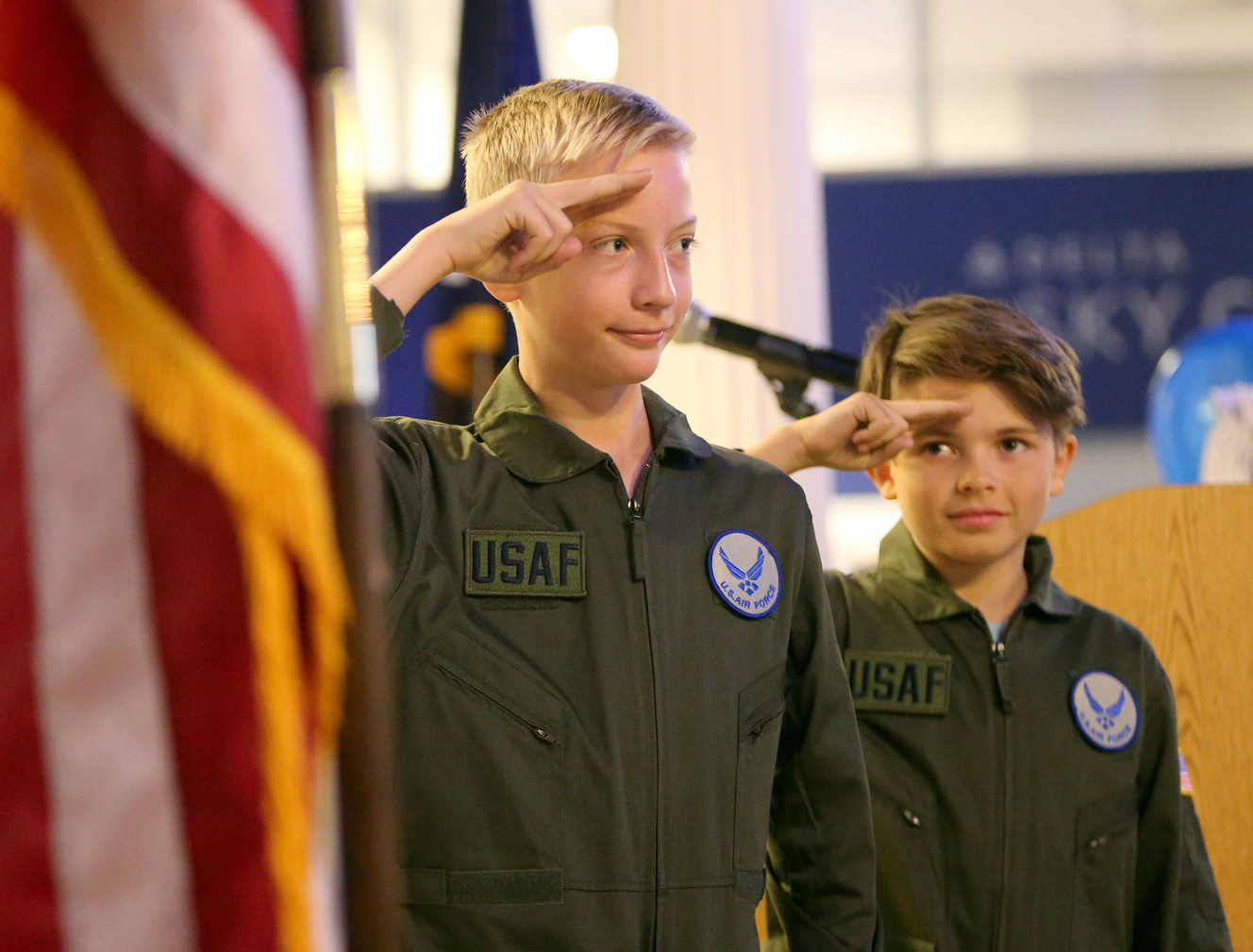 Skip Waugh and Seth Rushton salute during the national anthem before a ribbon-cutting ceremony for a new Hill Air Force Base air traffic control tower at Junior Achievement City at Discovery Gateway in Salt Lake City on Tuesday, April 10, 2018. (Photo: Kristin Murphy, KSL)