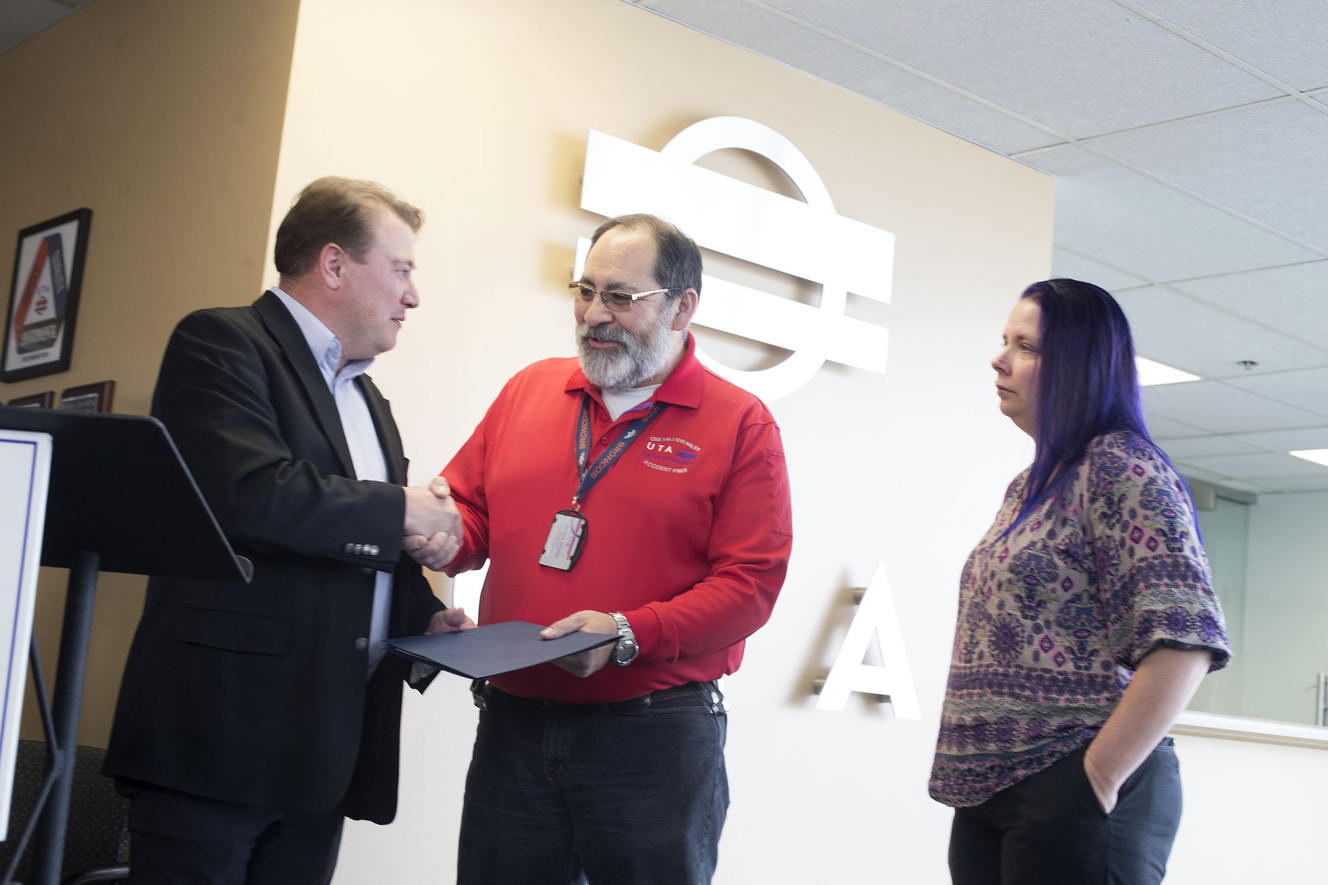 Bruce Cardon, Utah Transit Authority's commuter rail general manager, hands FrontRunner operator Francis Rendon a certificate of excellence as Ashley Kofford watches at the UTA headquarters in Salt Lake City on Wednesday, April 11, 2018. Kofford credits Rendon for saving her son's life. (Photo: Laura Seitz, KSL)