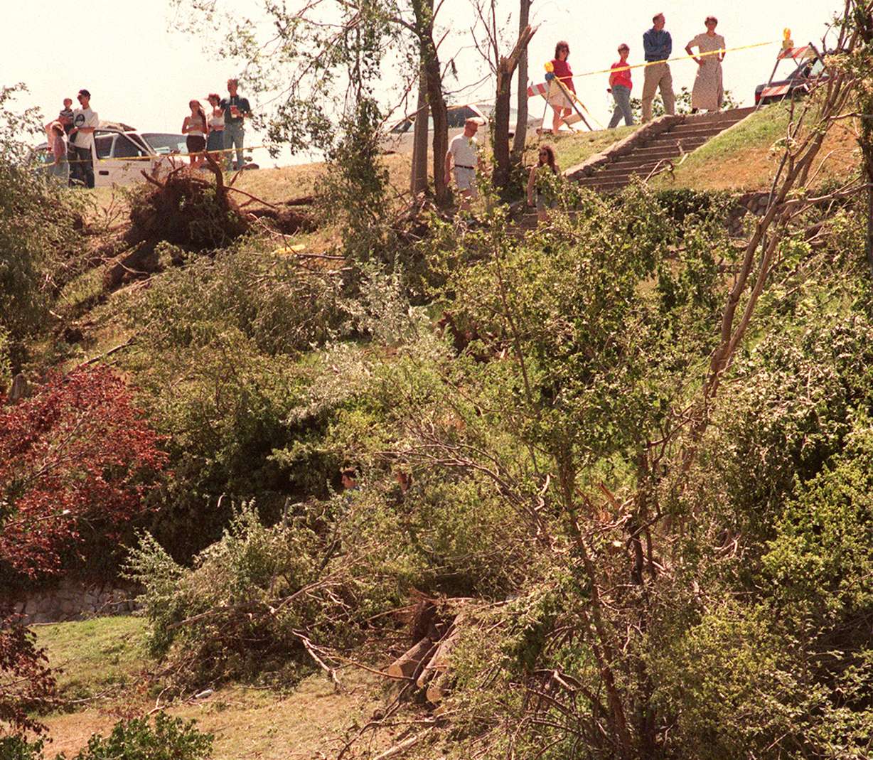 Visitors to Capitol Hill view the destruction from a tornado in Memory Grove on Aug. 14, 1999. (Photo: Marta Storwick, Deseret News)