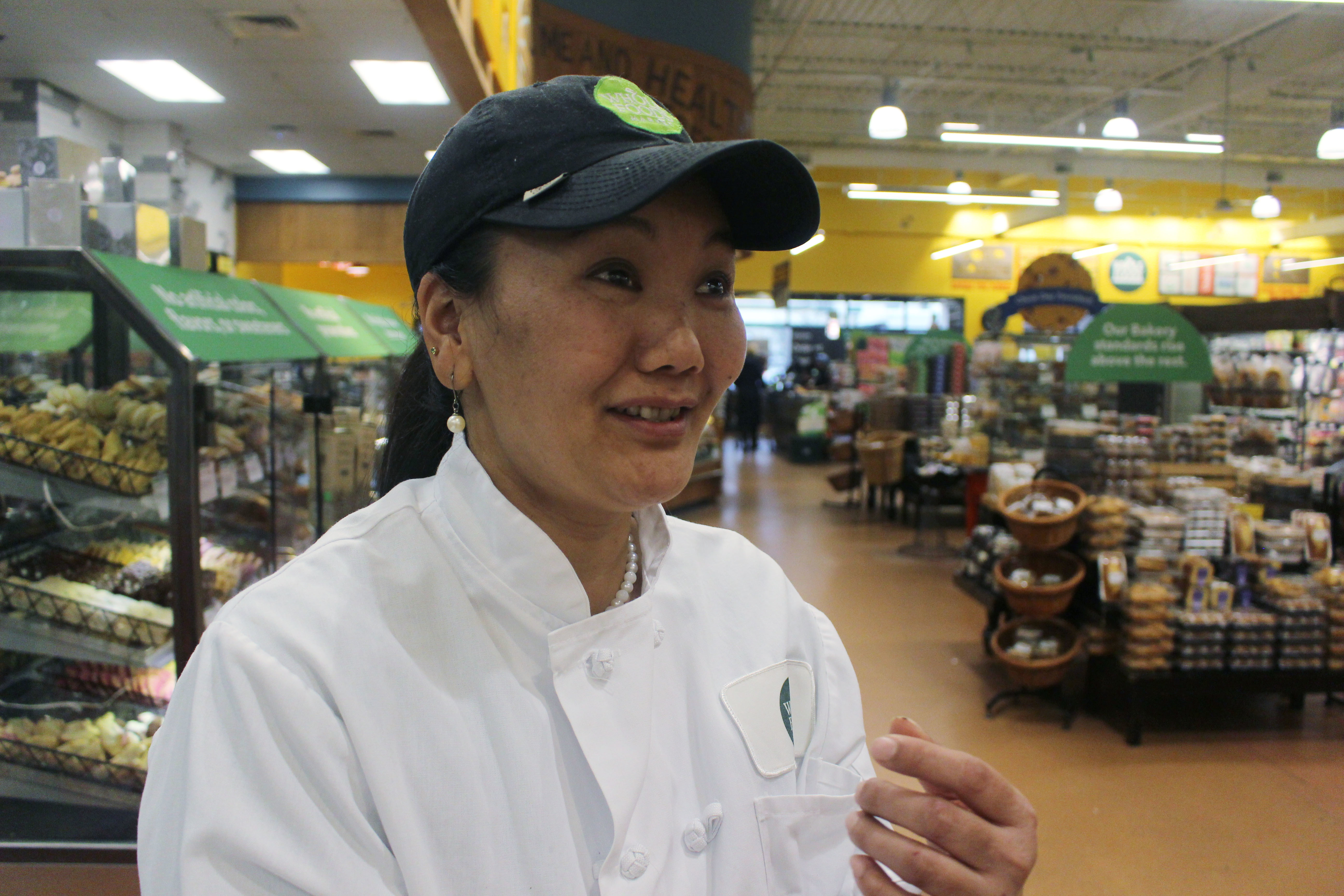 In this April 3, 2018, photo, mountain climber Lhakpa Sherpa prepares to start her shift as a dishwasher at the Whole Foods Market in West Hartford, Conn. Once a year Sherpa heads back to her native Nepal to try and break her own record for successful summits of Mount Everest by a woman. (AP Photo/Pat Eaton-Robb)