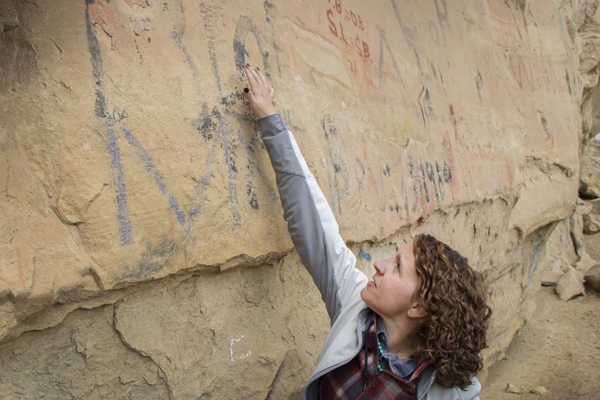 Elizabeth Hora, an archaeologist with Utah Division of State History, points out rock art next to graffiti at the Coalville Ledge in Coalville, Utah during a tour on Tuesday, April 17, 2018. The ledge holds all sorts of history dating back more than 1,000 years and even from pioneers to the area in the 19th Century, but also has been tagged by graffiti in recent years. (Photo: Carter Williams, KSL.com, File)