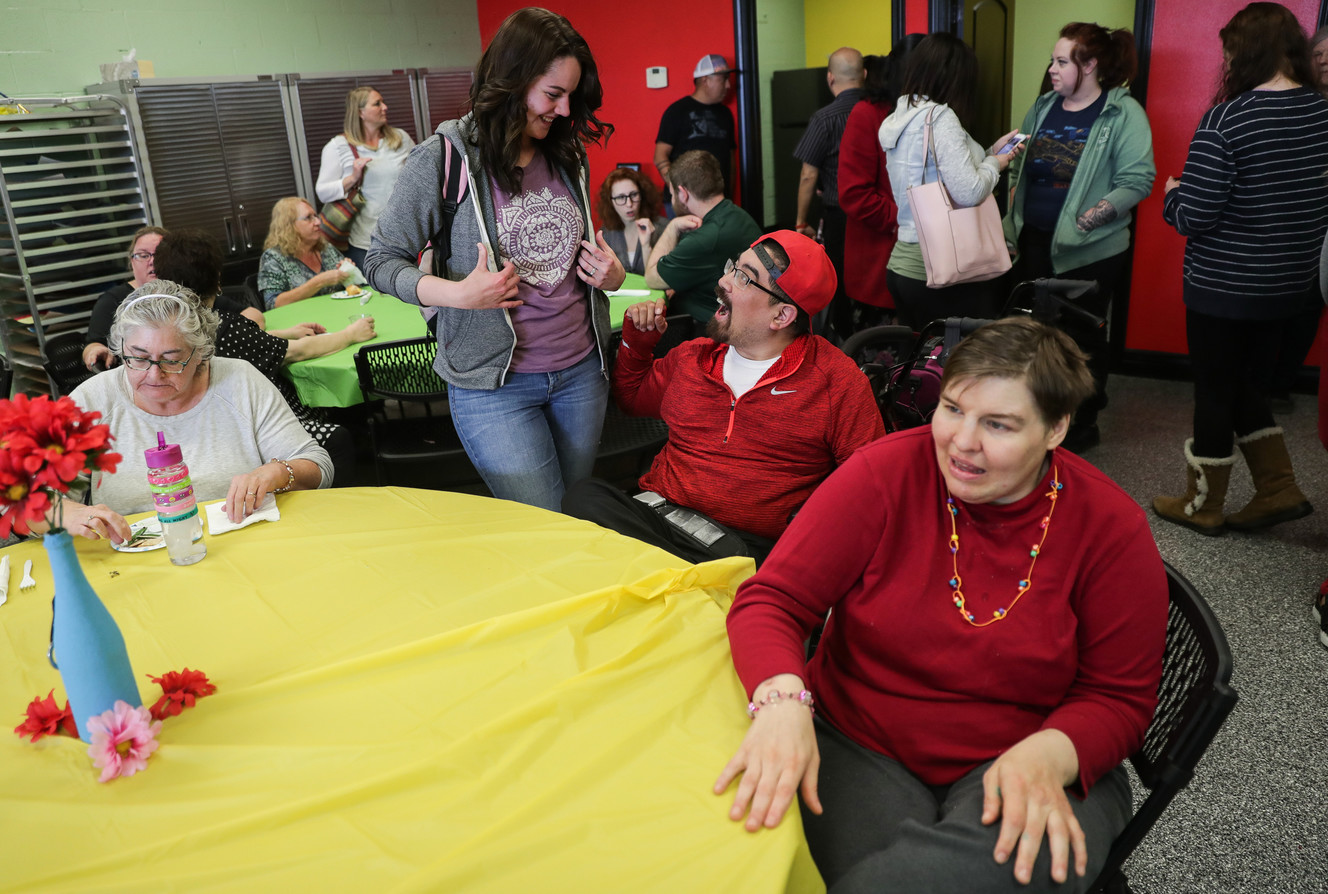 Kamree Fallentine, a direct support professional at TURN, second from left, chats with Stephen B. Park, center, and Andrea Ostler, right, at the opening of the new Everest Arts and Learning Center, a TURN Community Services Day Program, in American Fork on Wednesday, April 18, 2018. (Photo: Spenser Heaps, KSL)