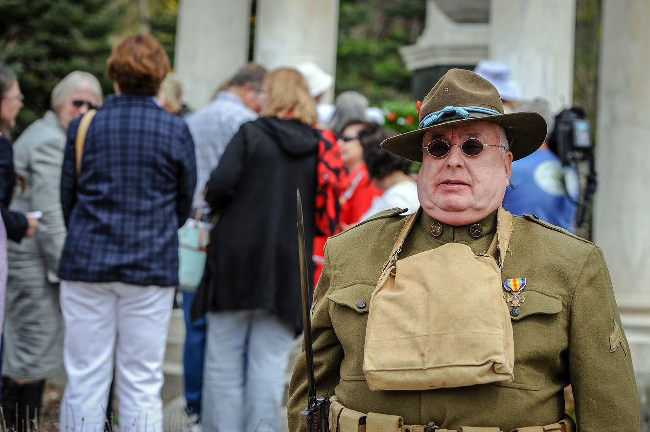 Chip Guarente, in a period uniform, stands guard as people place poppies in a wreath at the World War I Memorial at Memory Grove Park in Salt Lake City on Thursday, April 19, 2018. The Utah State Society of the National Society of the Daughters of the American Revolution hosted a wreath-laying ceremony to commemorated the 100th anniversary of the signing of the Treaty of Versailles in 1918. (Photo: Adam Fondren, KSL)
