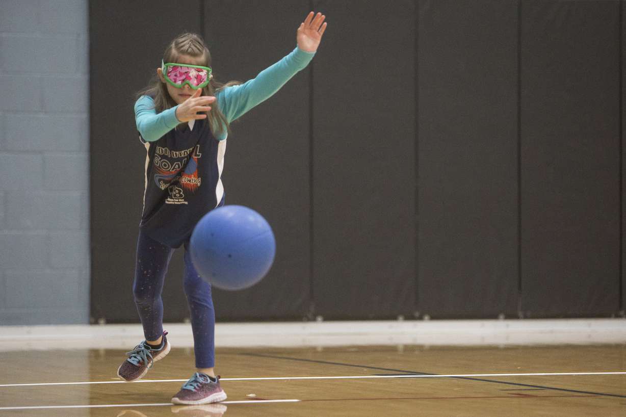 Kelsey Kartchner, 9, of Smithfield, serves the ball during the 2018 Utah State Goalball Youth Tournament at the Copperview Recreation Center on Friday, April 20, 2018, in Midvale. Goalball is a sport for the blind and visually impaired where competitors wear an eye shade to level the playing field for those with varying degrees of visual impairment. (Photo: Jacob Wiegand, Deseret News)