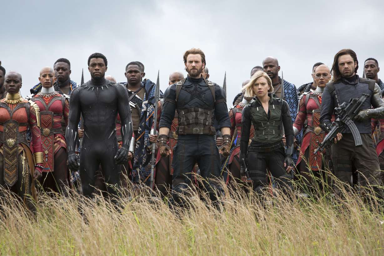 This image released by Marvel Studios shows, front row from left, Danai Gurira, Chadwick Boseman, Chris Evans, Scarlet Johansson and Sebastian Stan in a scene from "Avengers: Infinity War," premiering on April 27. (Chuck Zlotnick/Marvel Studios)