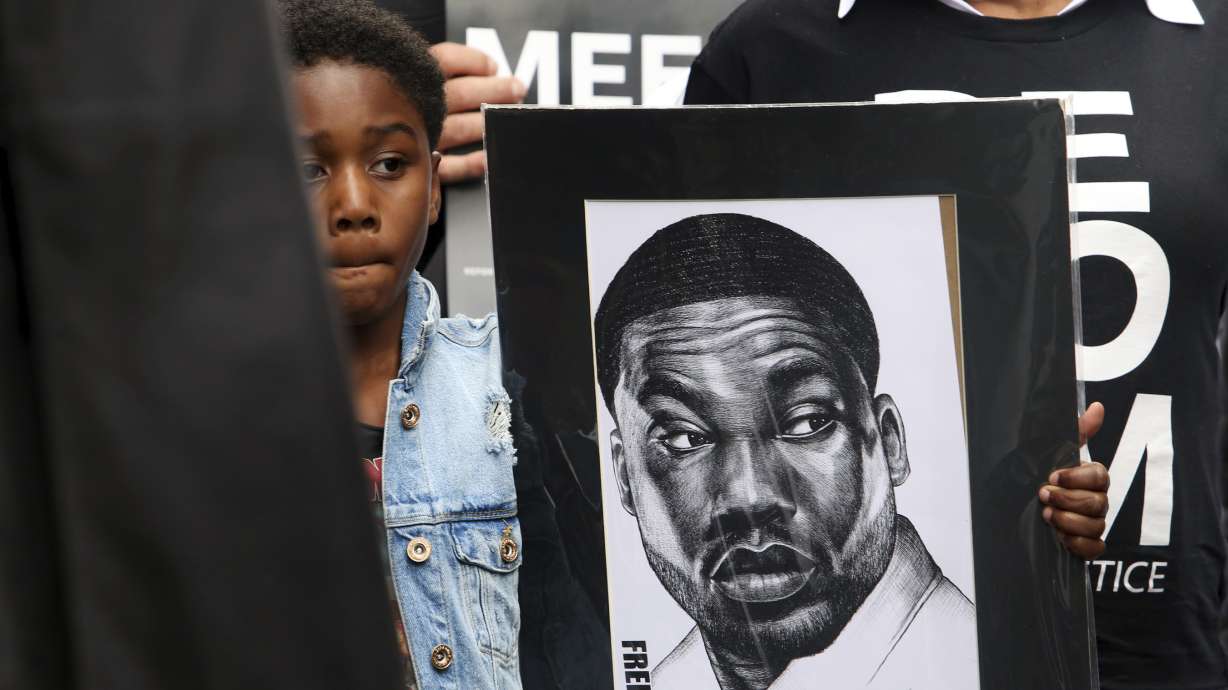 The Latest: Rapper Meek Mill rings bell at basketball game