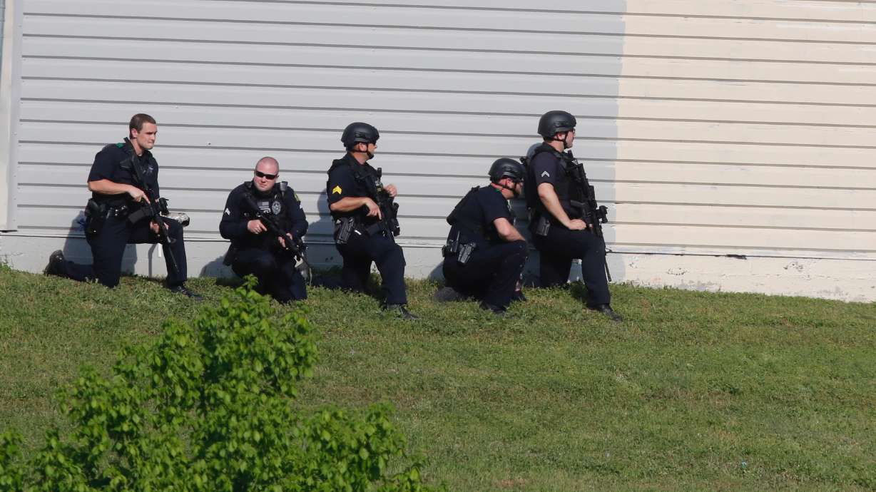 The Latest: Dallas officers out of surgery, arrest made