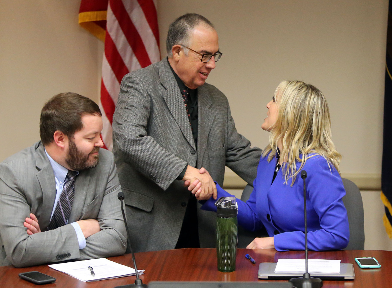 Sam Granato shakes hands with Aimee Winder Newton as she takes a seat in her new role as Salt Lake County Council's chair, and the council's first female chair, at the Salt Lake County Govenment Center in Salt Lake City on Tuesday, Jan. 9, 2018. Arlyn Bradshaw is on the left. (Photo: Kristin Murphy, KSL File photo)