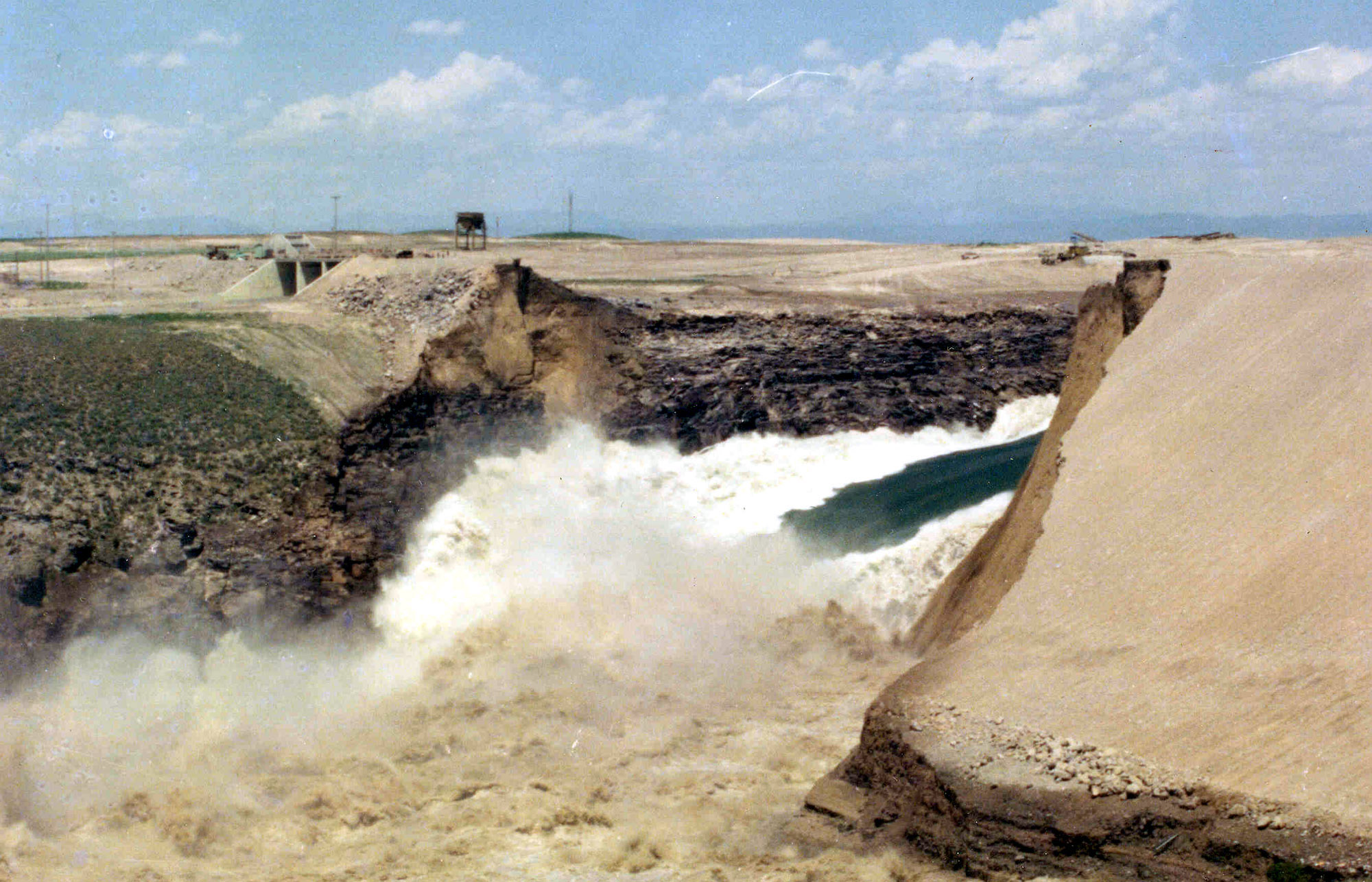 This image proved by the U.S Bureau of Reclamation shows the Teton Dam bursting on June 5, 1976, about 20 miles northeast of Rexburg, Idaho. When this brand-new dam gave way in 1976, 80 billion gallons of water surged down the valley of eastern Idaho farming towns, destroying hundreds of homes, 18,000 head of livestock and 11 lives. Structure at left was the dam's spillway. (U.S. Bureau of Reclamation, AP Photo, File)