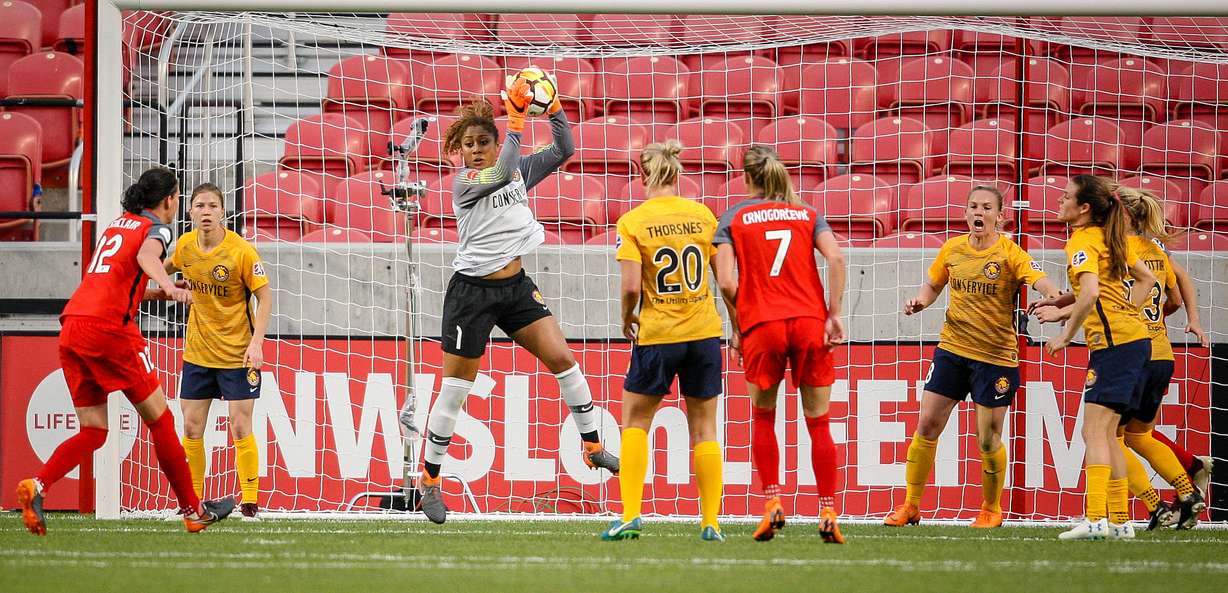 Utah Royals FC goalkeeper Abby Smith (1) reaches up and grabs a shot on goal in the first as the Utah Royals host the Portland Thorns at Rio Tinto Stadium in Sandy on Saturday, April 28, 2018. (Photo: Adam Fondren, Deseret News)