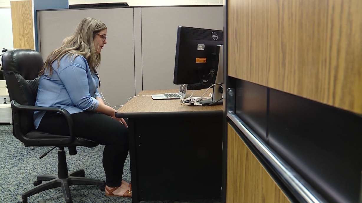 Emilee Taylor's job during class time is to listen to the teacher and interpret the lesson to Kaylee Miller in sign language. (Photo: KSL TV)