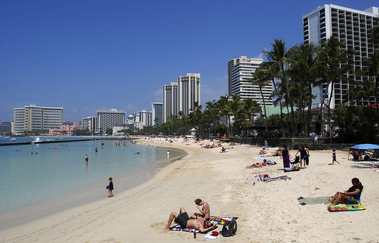 People relax on the beach at Waikiki in Honolulu March 13, 2017. Photo: AP Photo
