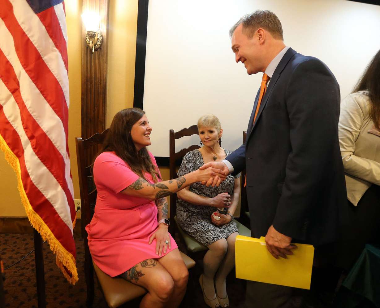 Matilda Lindgren, program director for The INN Between, shakes hands with Salt Lake County Mayor Ben McAdams after a press conference at Hillside Rehabilitation Center, which will become the new The INN Between, a hospice facility for the homeless, in Salt Lake City on Thursday, May 3, 2018. Linda Lemieux, a resident at The INN Between who has liver disease, sits between them. (Photo: Kristin Murphy, KSL)