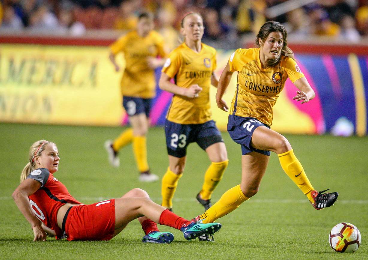 After a leaping a slide tackle b y Portland Thorns FC midfielder Lindsey Horan (10) Utah Royals FC forward Katie Stengel (24) controls the ball as the Utah Royals host the Portland Thorns at Rio Tinto Stadium in Sandy on Saturday, April 28, 2018. (Photo: Adam Fondren, Deseret News)